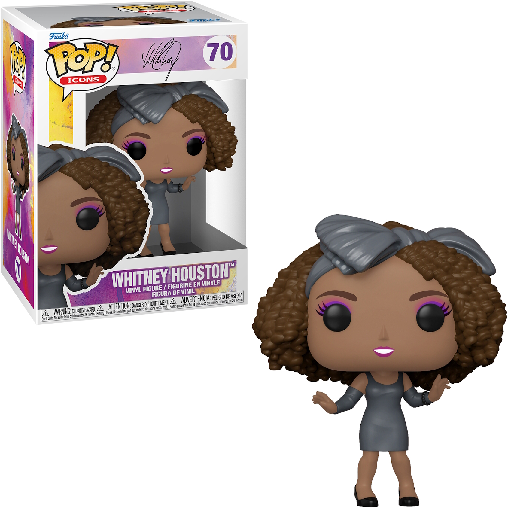 Figurka Whitney Houston w pudełku, w szarej sukience i opasce, z różowym makijażem.