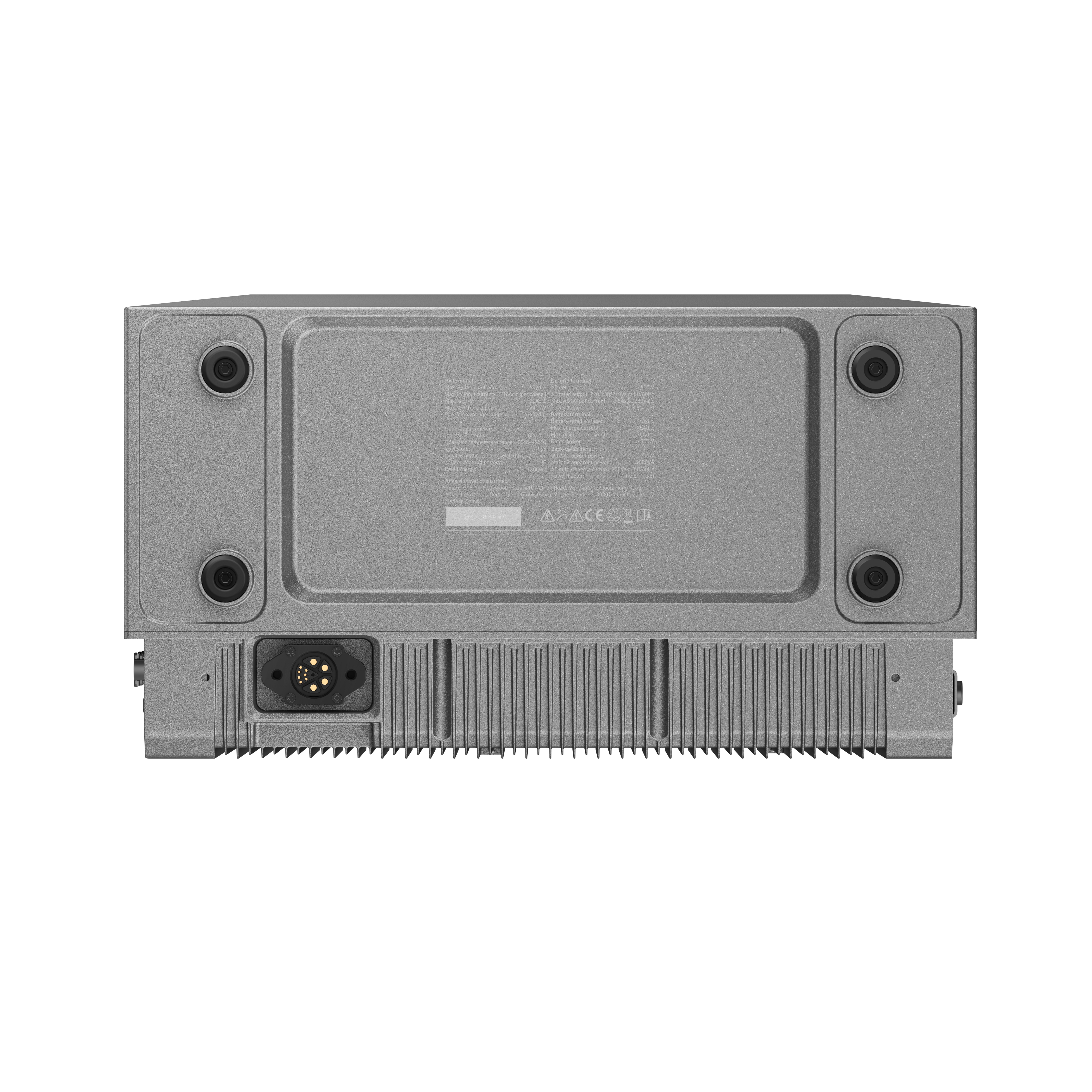 Spód szarego urządzenia, ze złączami i czarnymi gumowymi nóżkami.