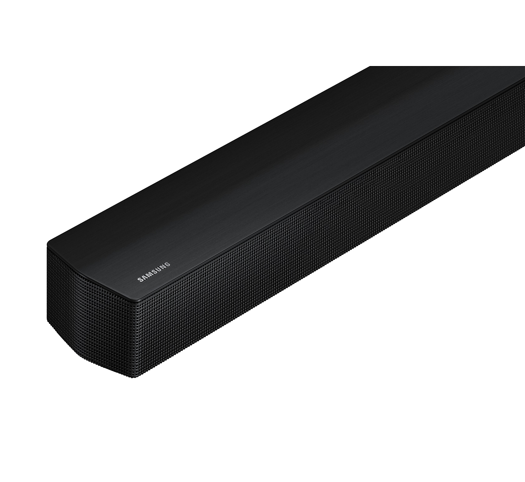 Barra de sonido Samsung negra, rectangular, con frontal de malla, sobre superficie blanca.