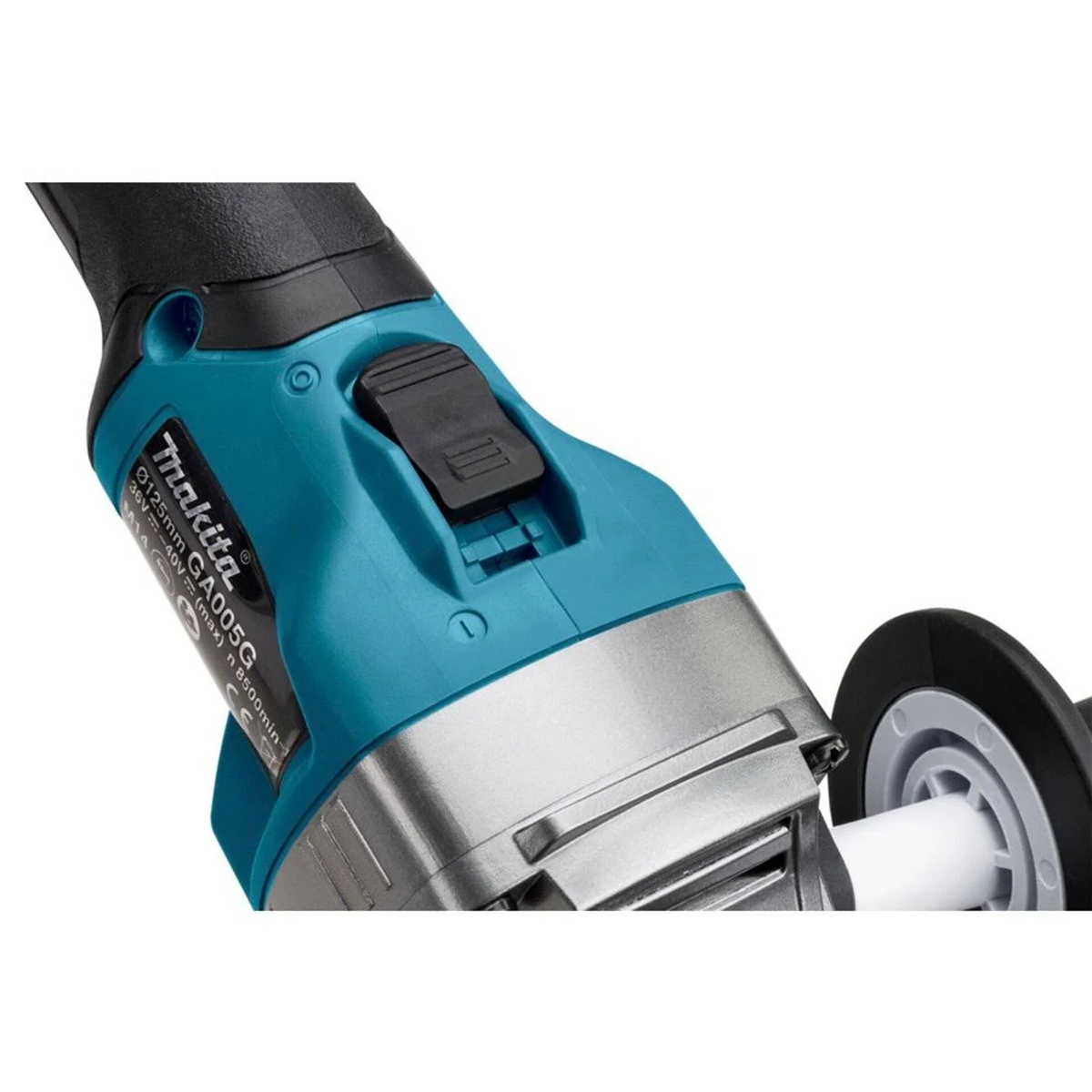 Primer plano de una amoladora Makita turquesa y negra. Un botón negro en la parte superior, la rueda es visible.