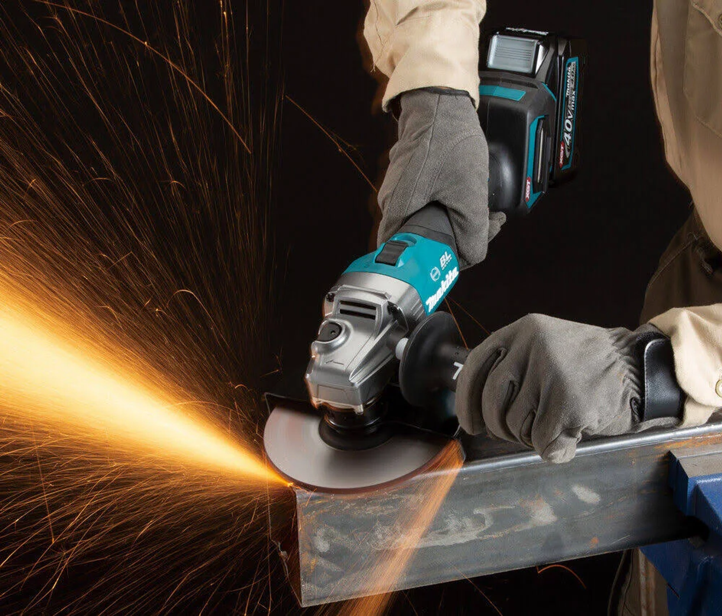 Osoba używająca teal szlifierki kątowej Makita z iskrami.