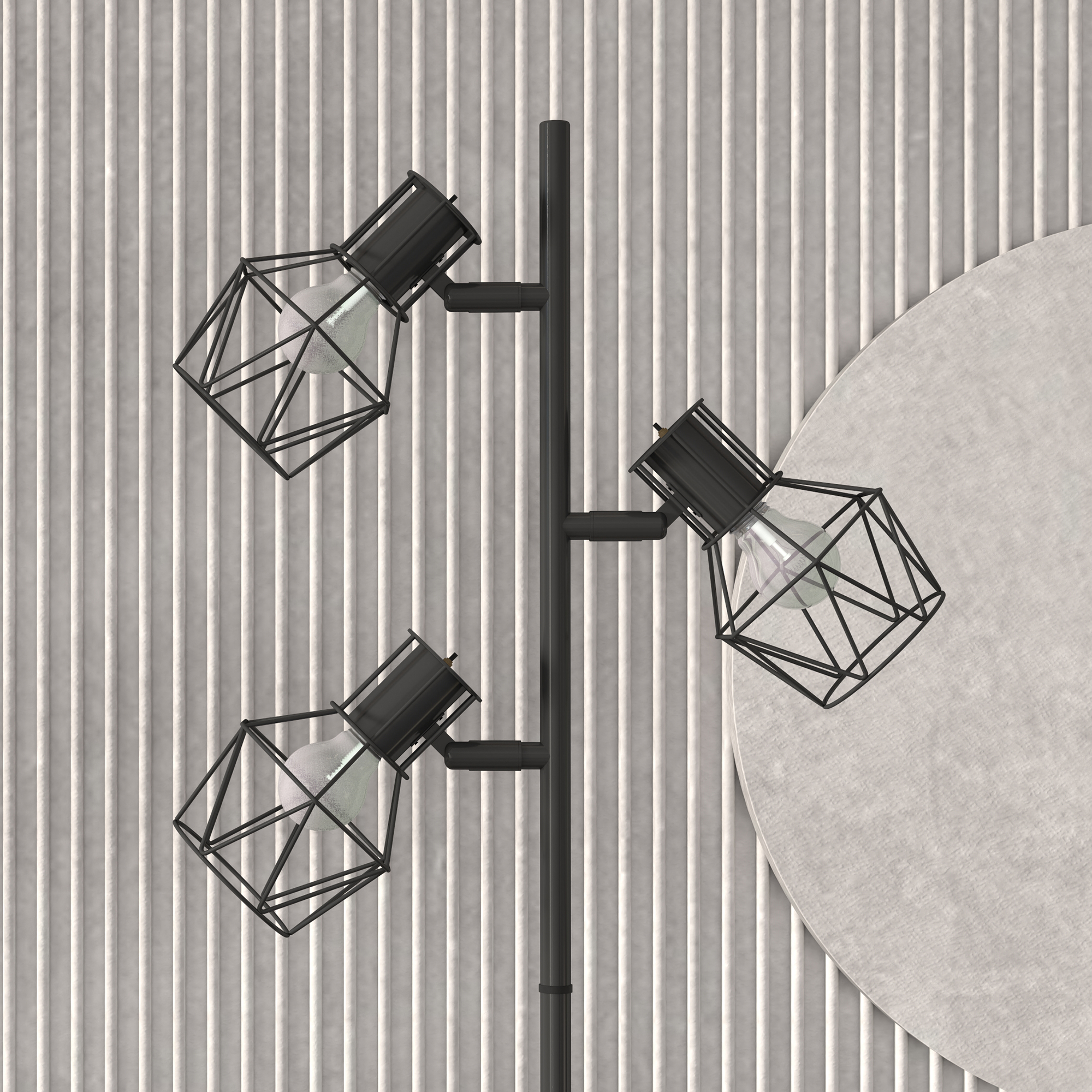 Una lampada da terra nera con tre luci geometriche a filo. Un cerchio bianco dietro la lampada.