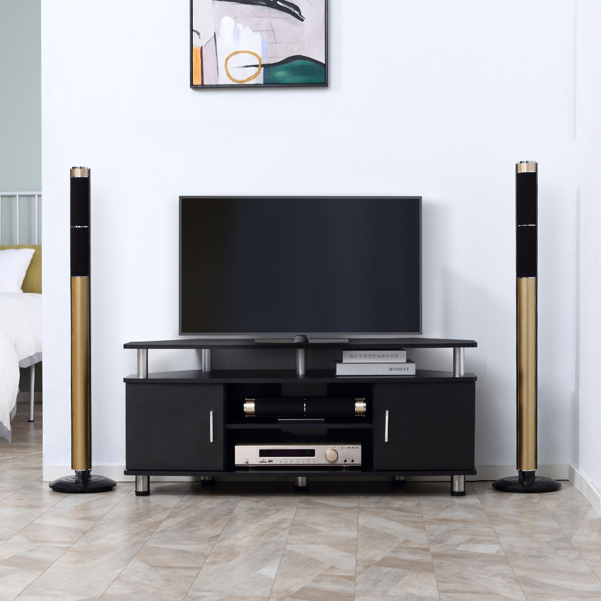Un mobile nero per l'intrattenimento con TV, altoparlanti e impianto stereo. Muri bianchi.