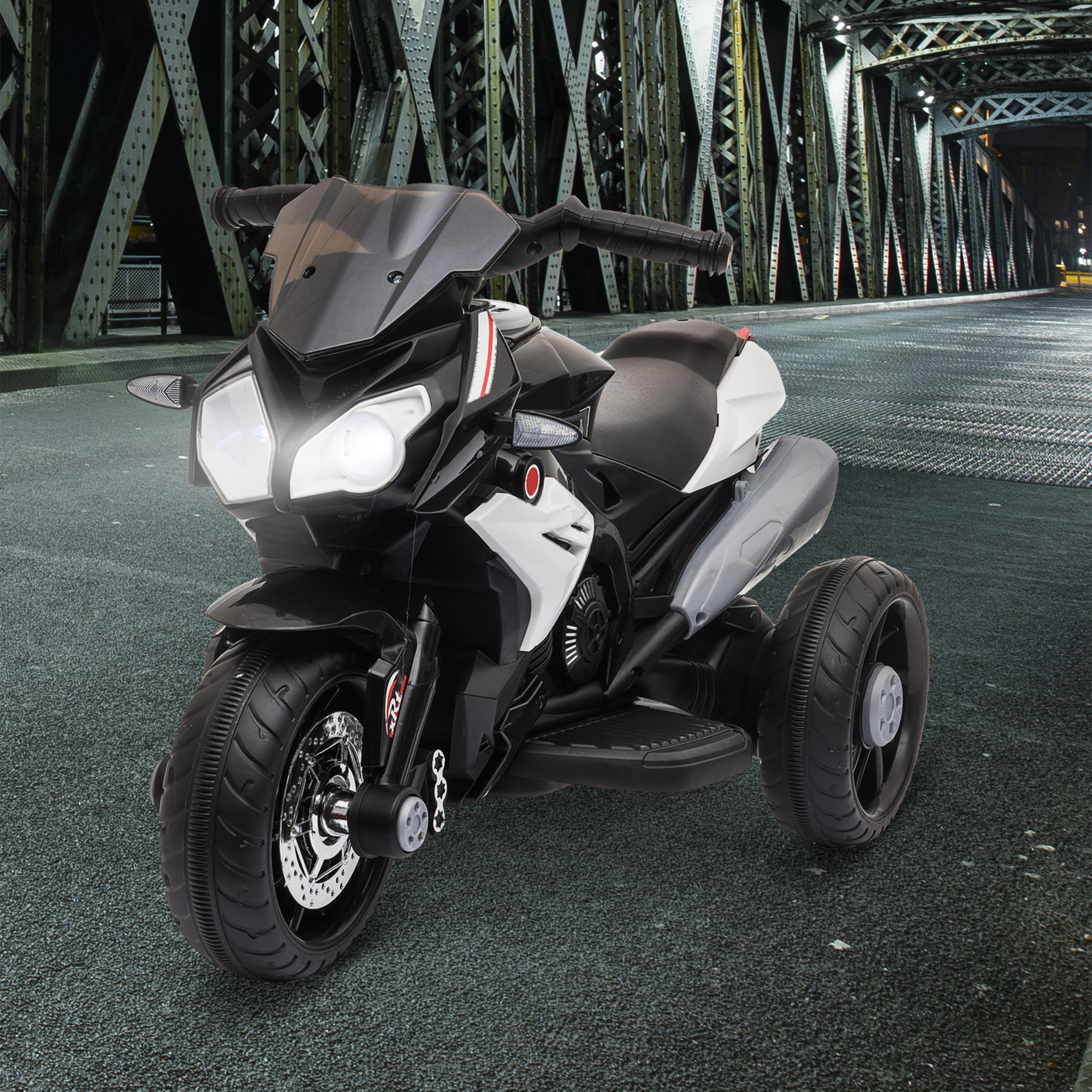Una moto giocattolo in bianco e nero con le luci accese è mostrata su una strada notturna.