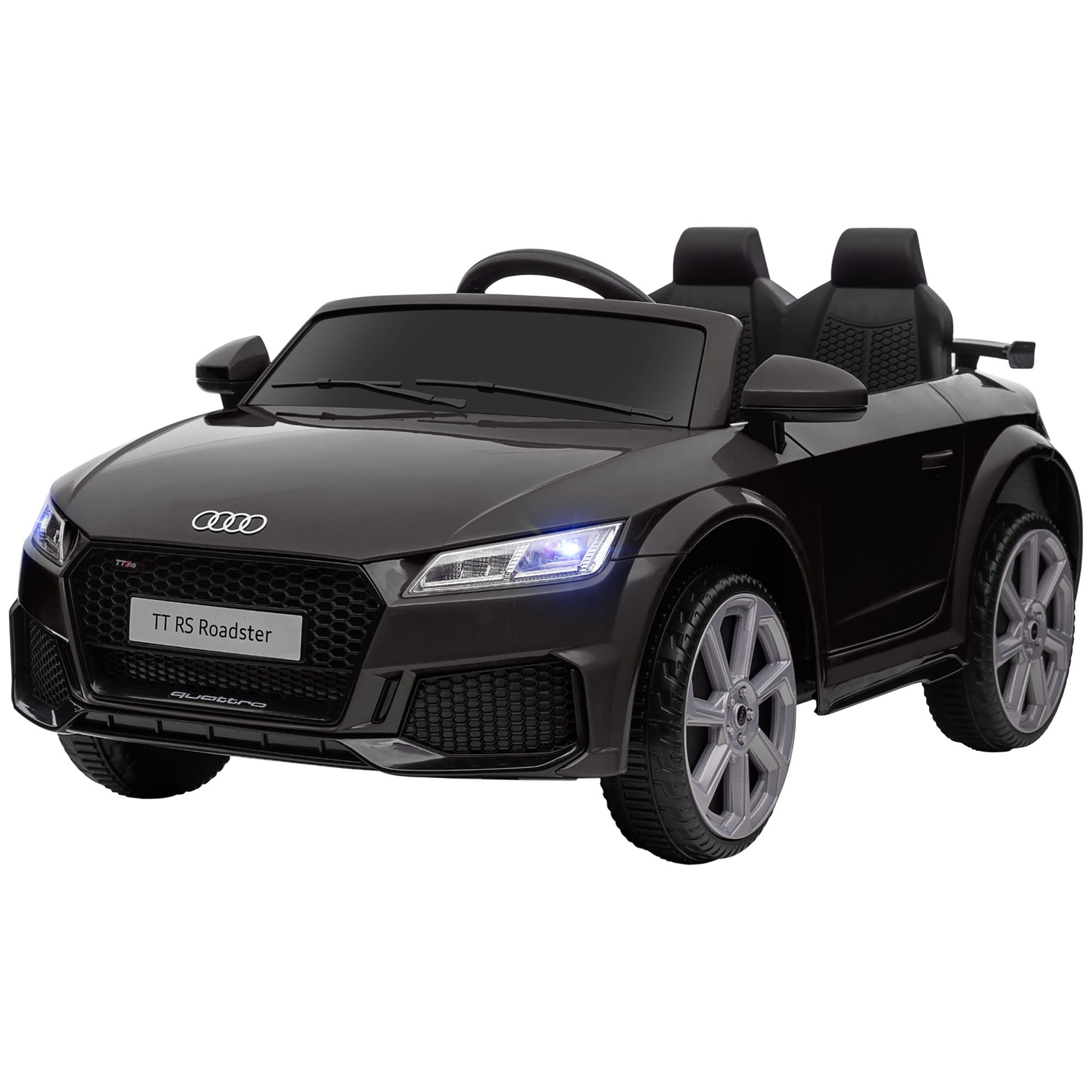 Audi TT RS Roadster giocattolo nero. Ha due posti, fari accesi e ruote grigie, su sfondo bianco.