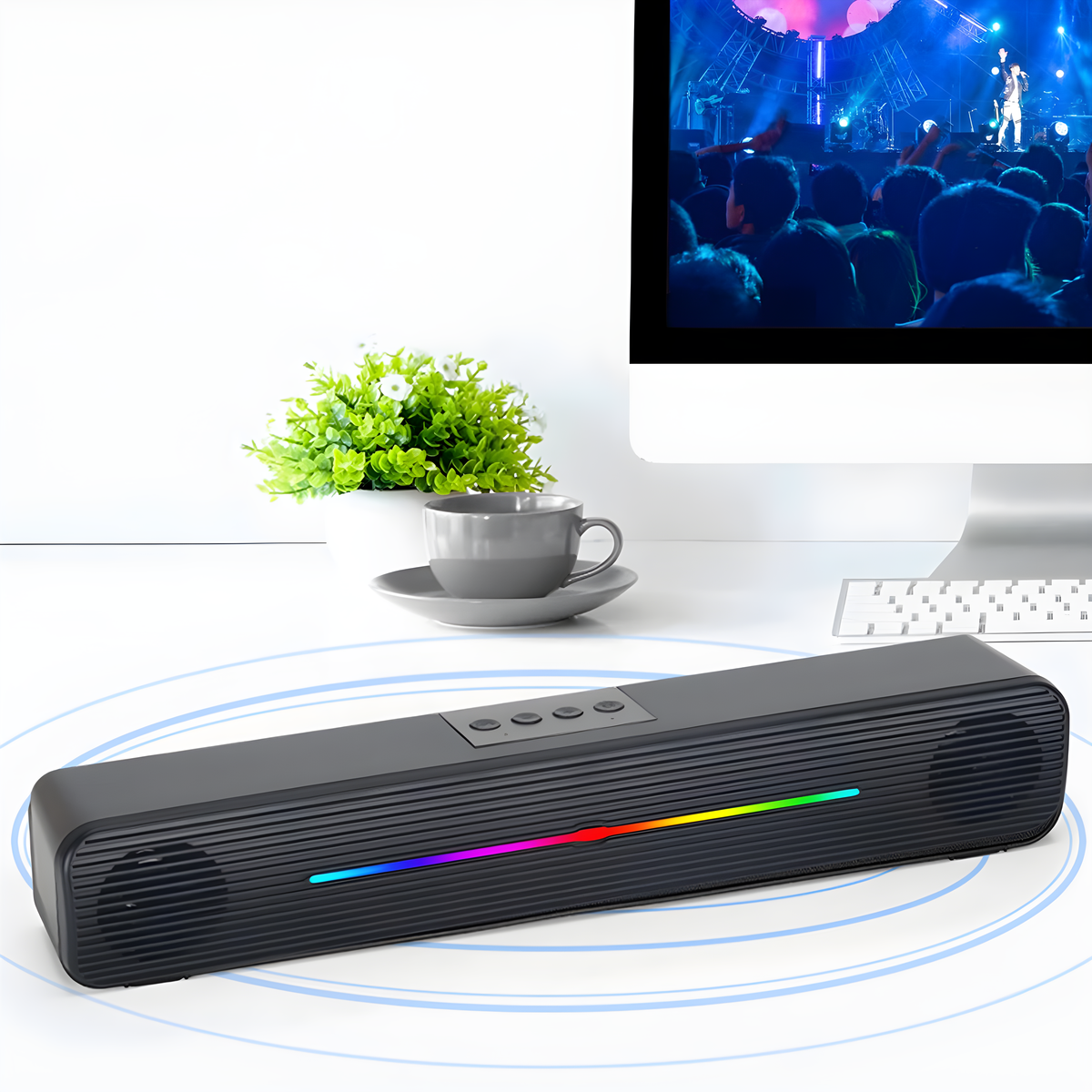 Eine schwarze Soundbar mit einem Regenbogen-Lichtstreifen und einem Konzert im Hintergrund.