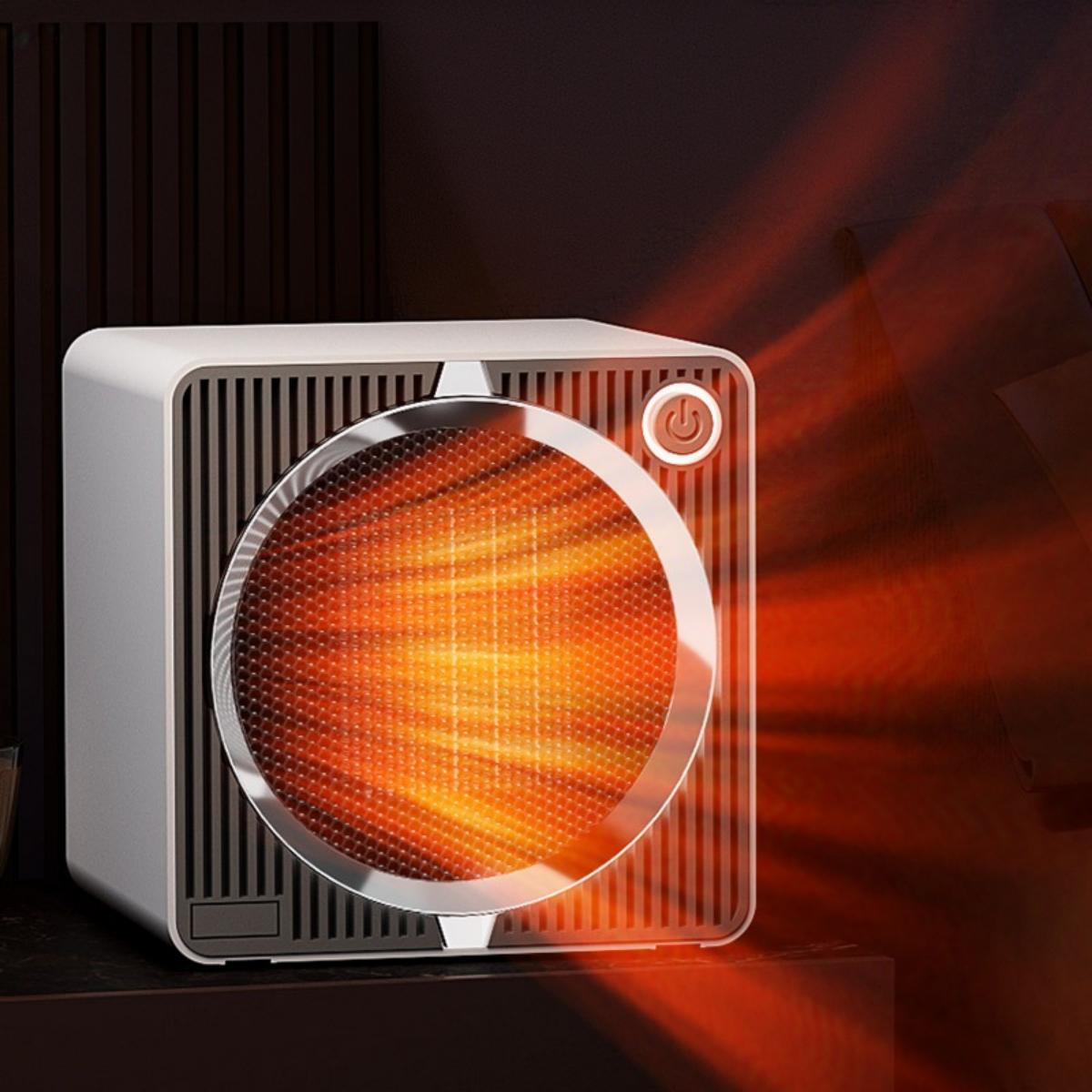 Ein kleiner, weiß-schwarzer Heizlüfter mit einem heißen, orangefarbenen Heizelement.