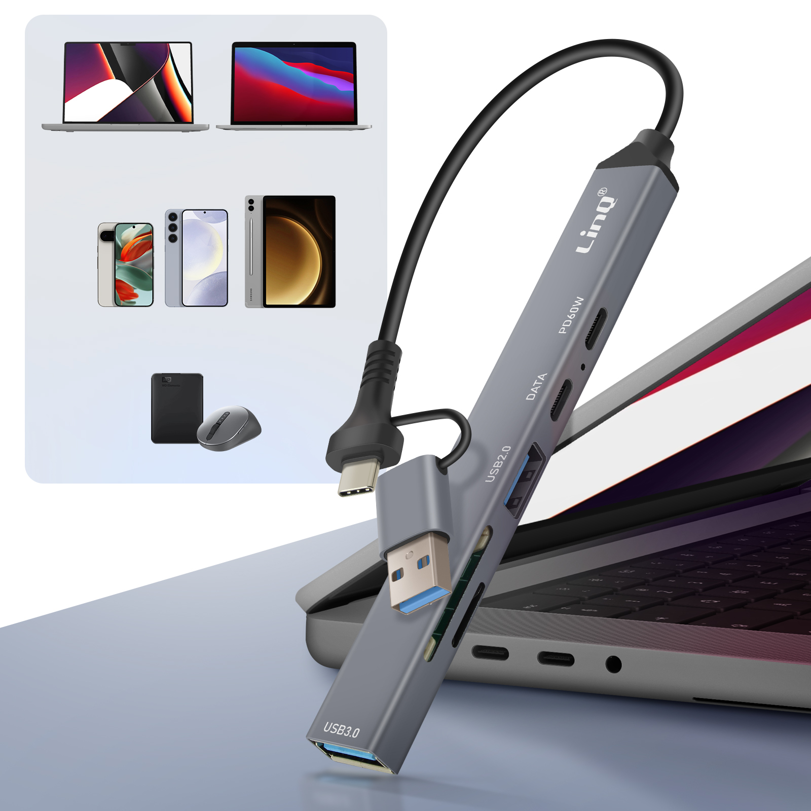 Hub USB gris avec ordinateur portable, téléphones et accessoires en arrière-plan.