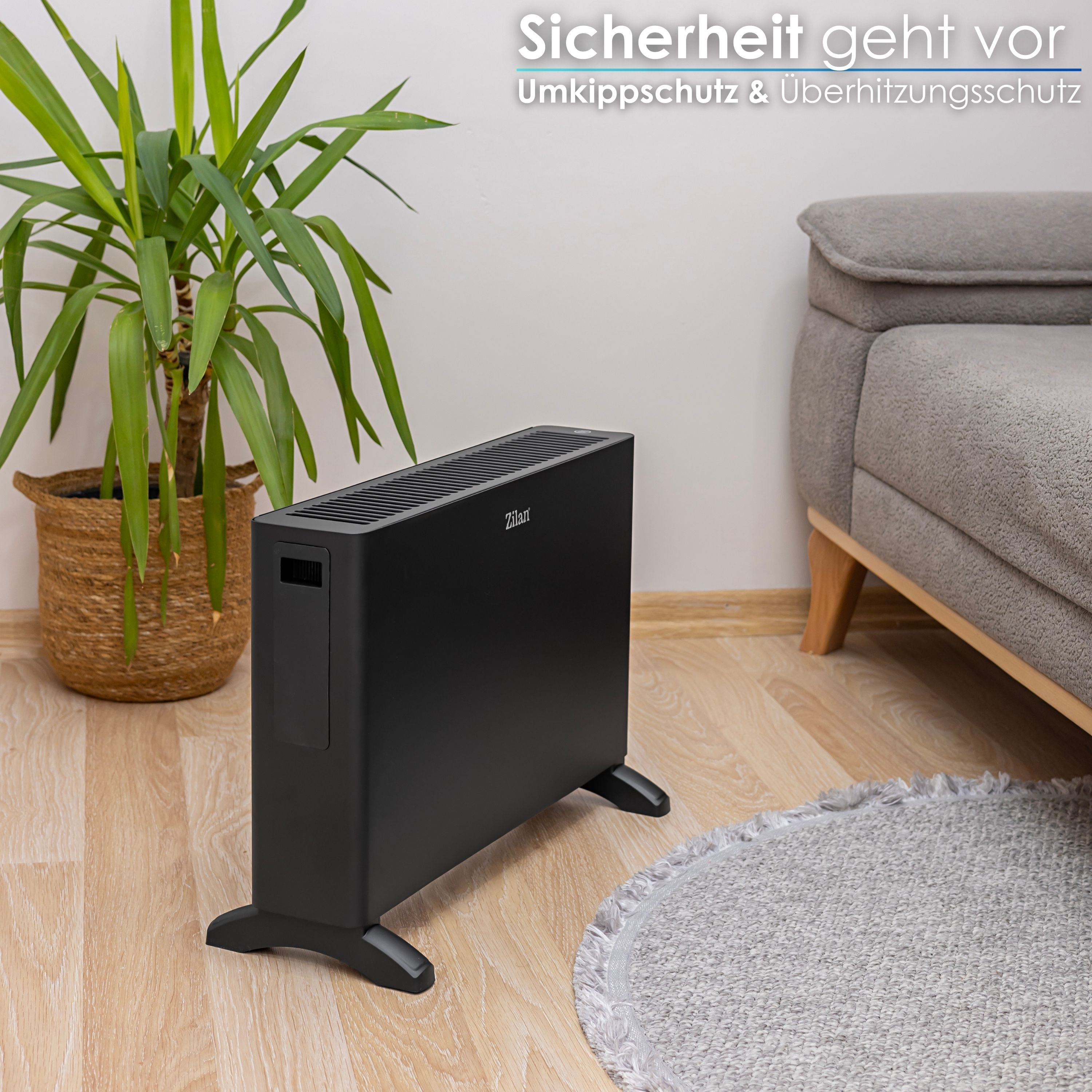 Schwarzer Heizkörper neben einem Sofa und einer Pflanze, mit Text: Sicherheit geht vor.