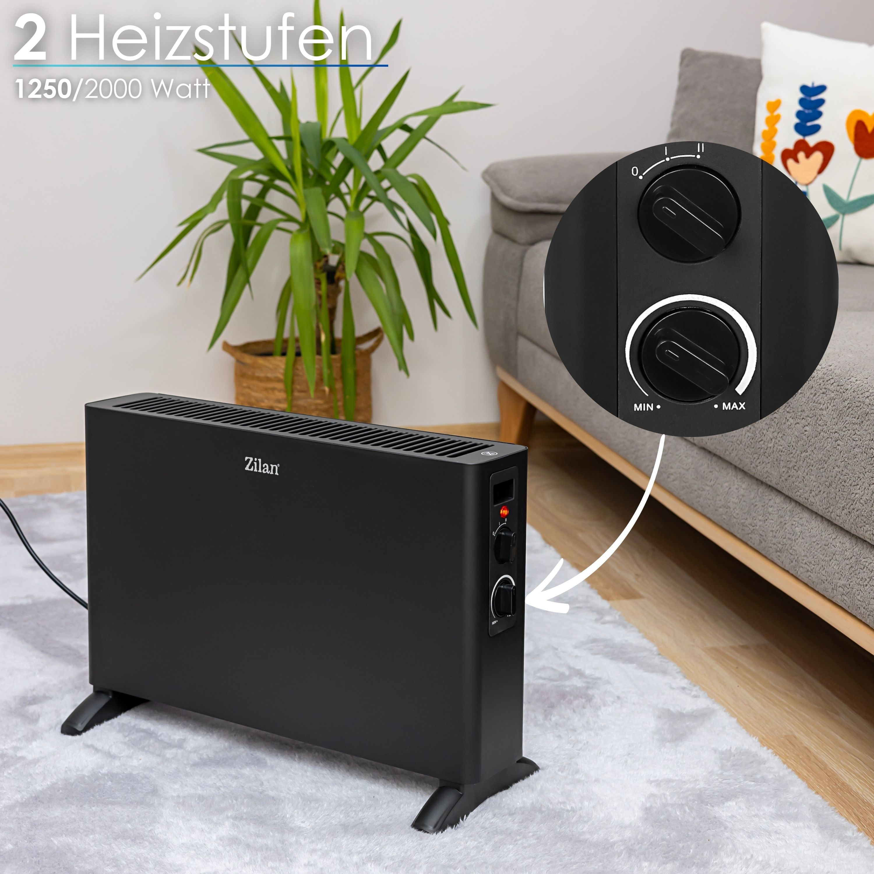 Ein schwarzer Elektroheizer mit Bedienelementen, auf einem Teppich mit einem grauen Sofa und einer Pflanze.