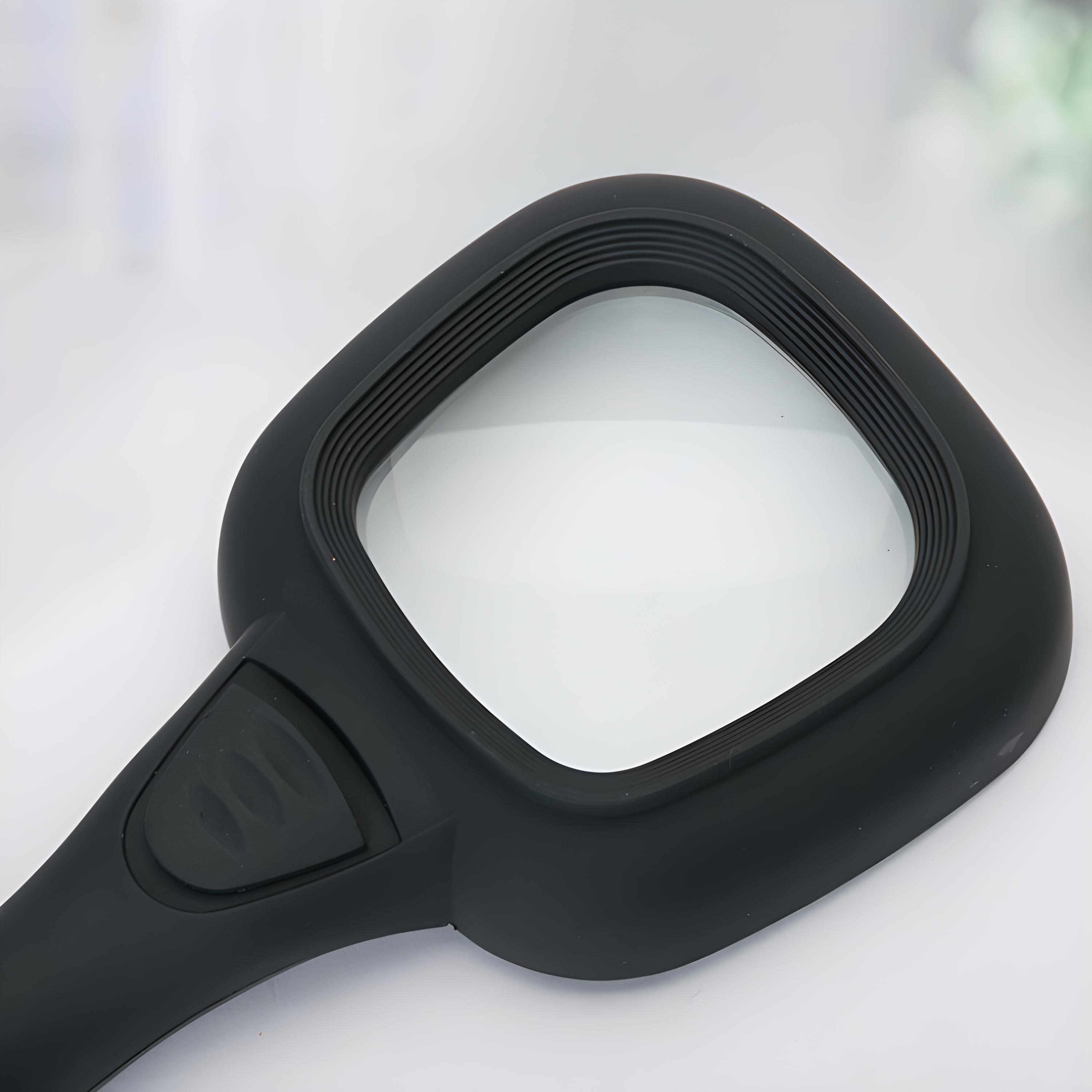 Eine schwarze Lupe mit quadratischer Linse.