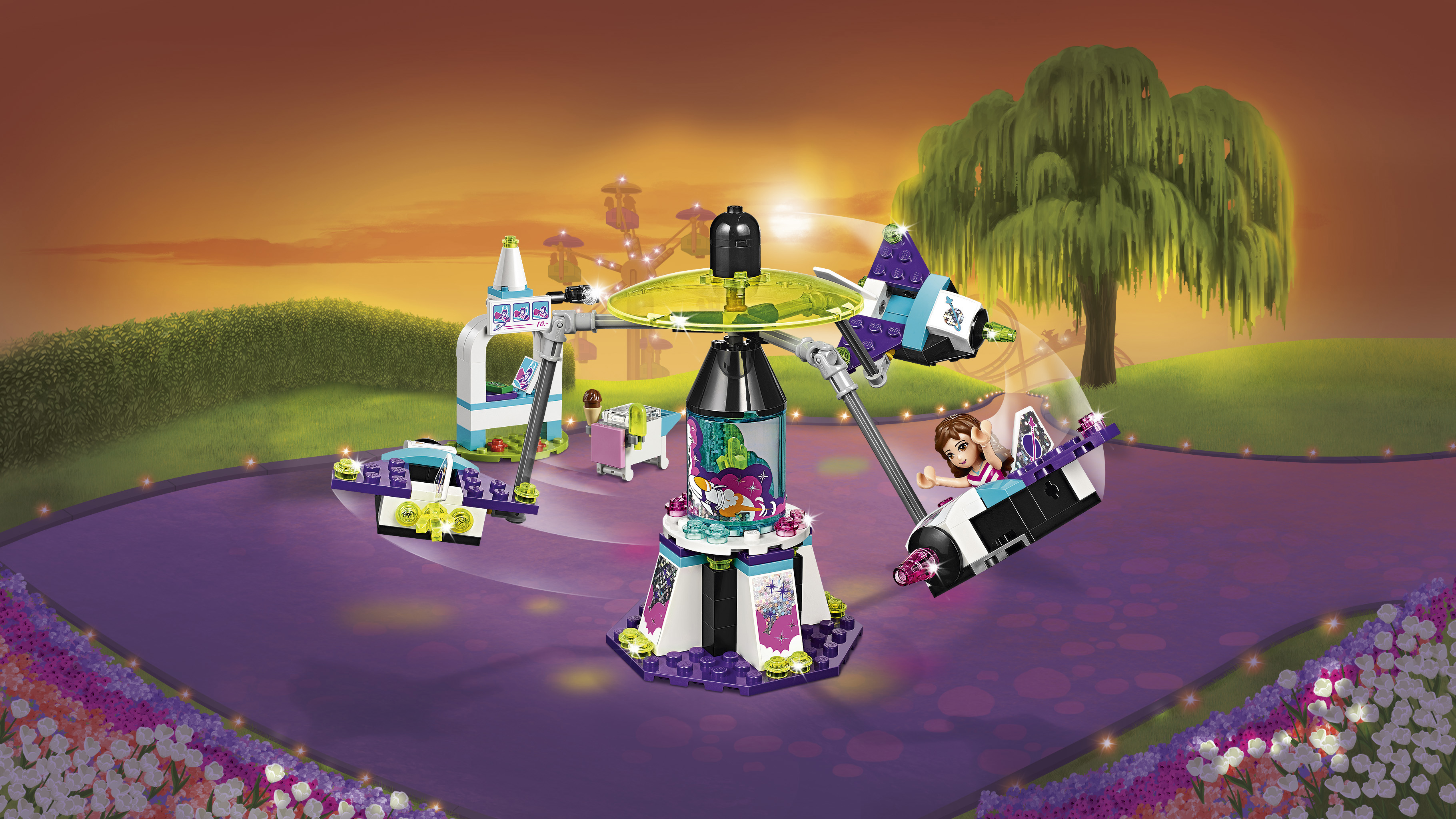 Lego Friends attractieparkset met meerdere figuren en een zonsonderganghemel.