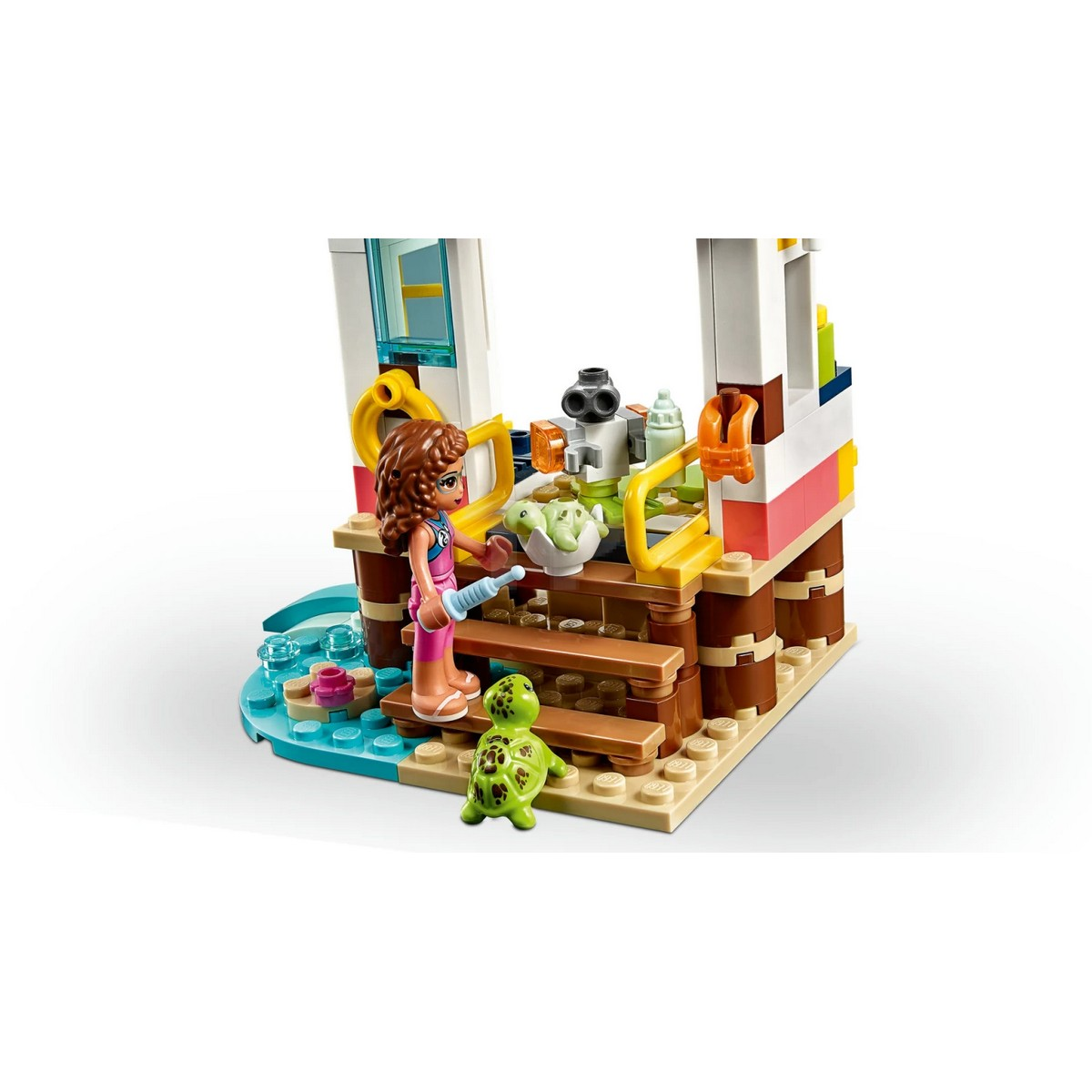 Zestaw Lego Friends, przedstawiający molo z dziewczynką i dwoma żółwiami oraz plażą.