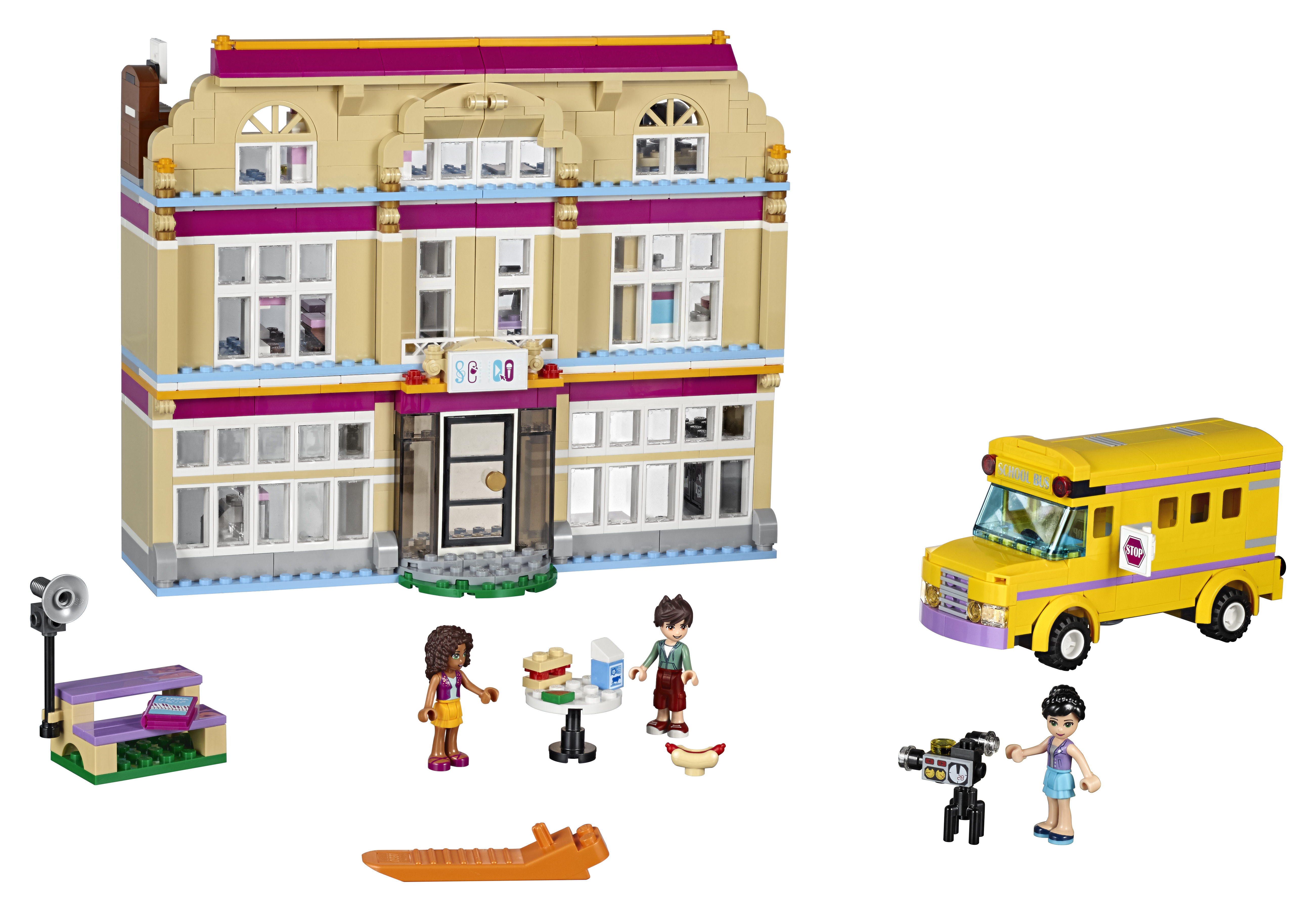 Zestaw Lego Friends: budynek szkoły, żółty autobus szkolny, mini-figurki i akcesoria na białej powierzchni.