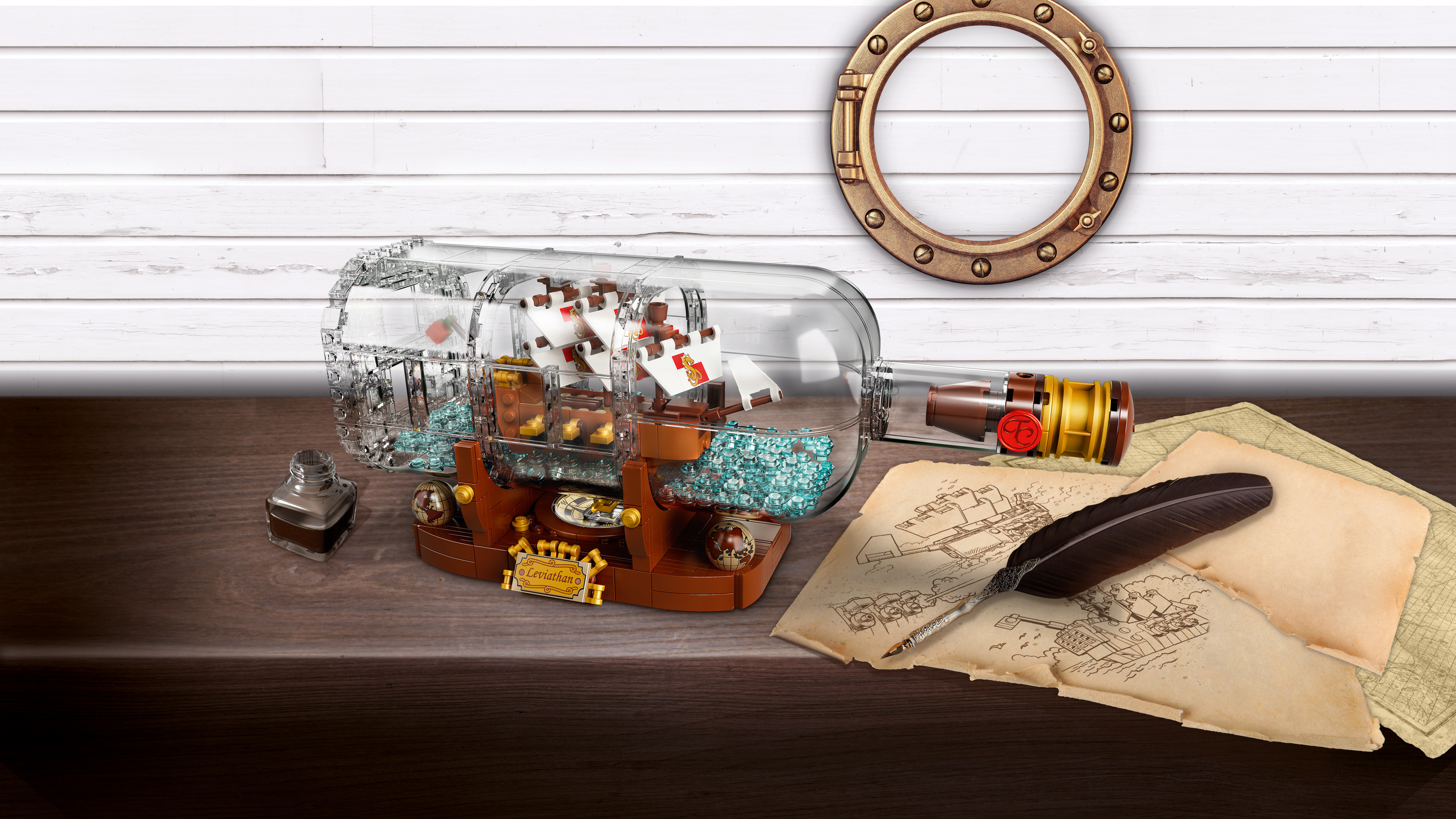 LEGO ship in a bottle set. A detailed ship inside a clear bottle on a wooden table.