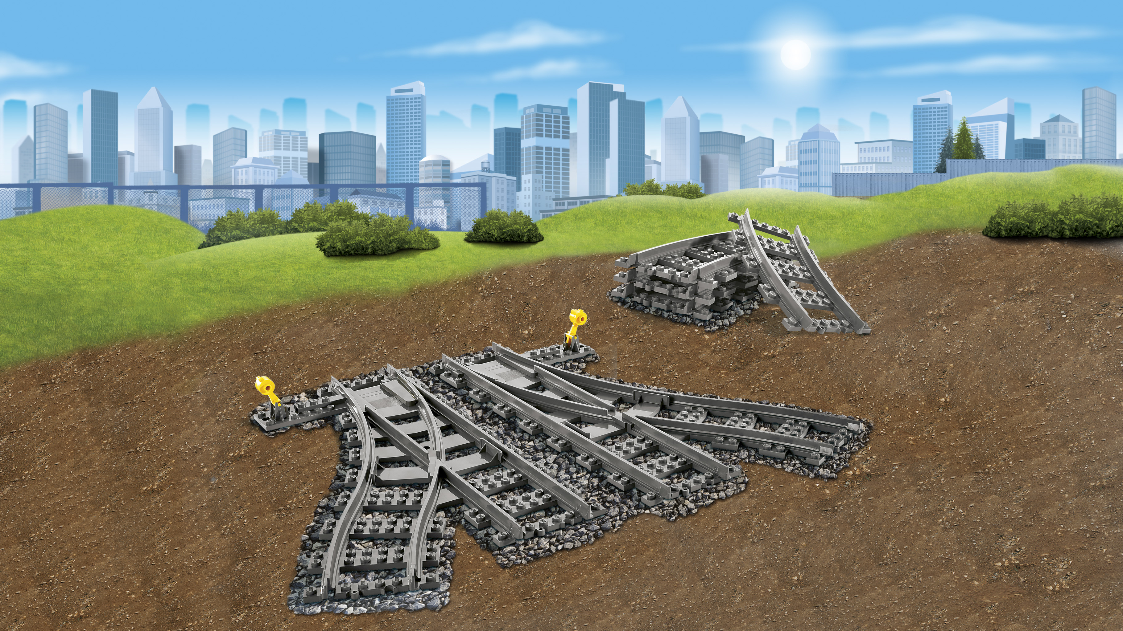 Set di binari Lego. Mostra binari ferroviari e uno sfondo di una città e un cielo blu con nuvole.