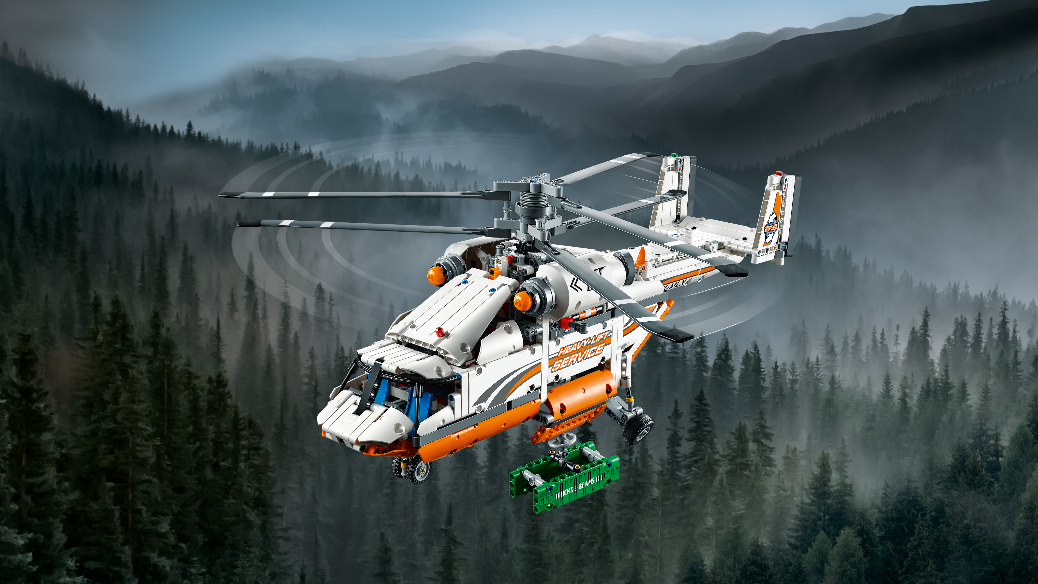 Lego Technic helikopter. Wit en oranje met een groene container.
