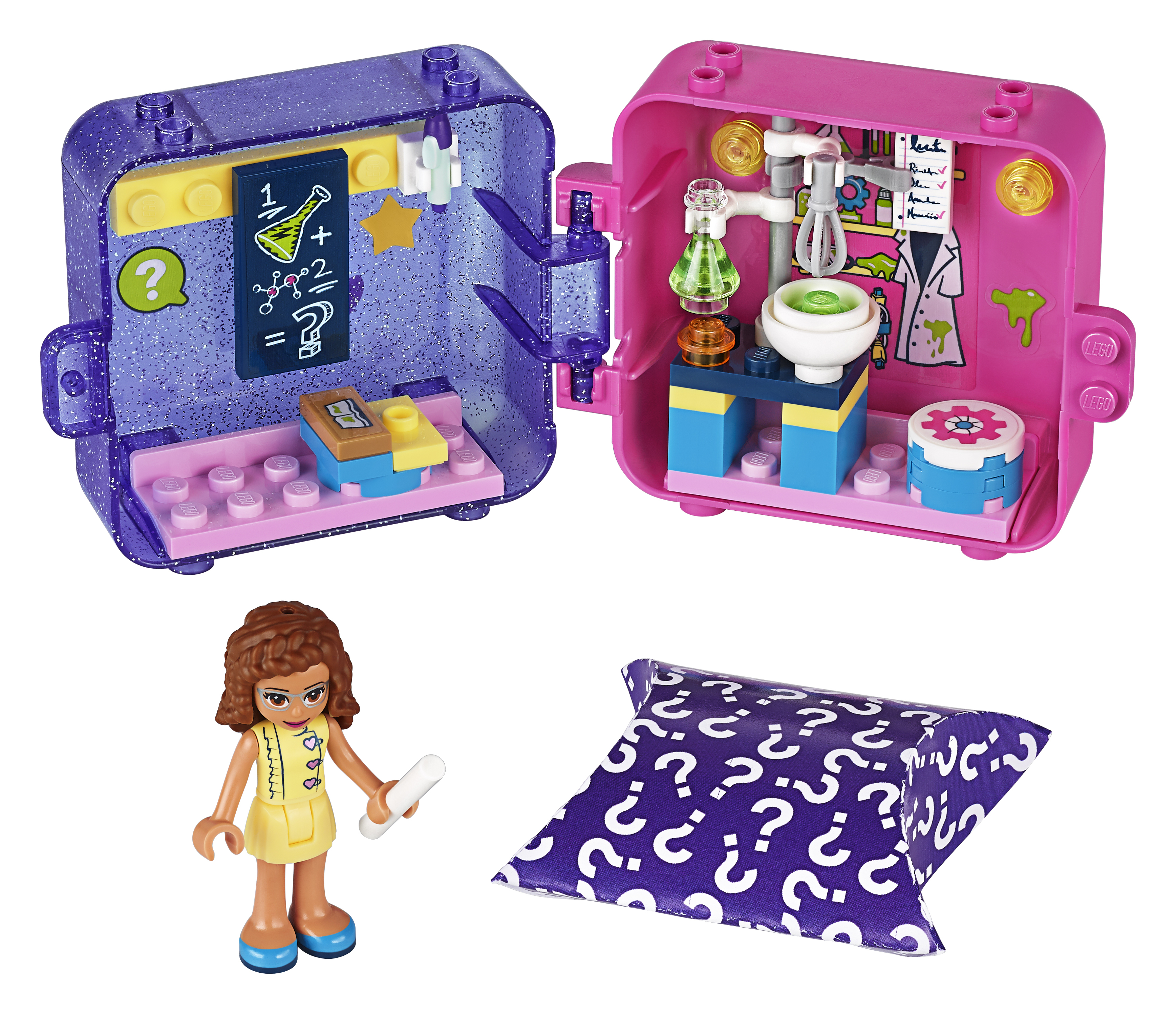 Lego Friends seti. Bir beher tutan bir figürle bir bilim laboratuvarı. Ön planda bir kutu.