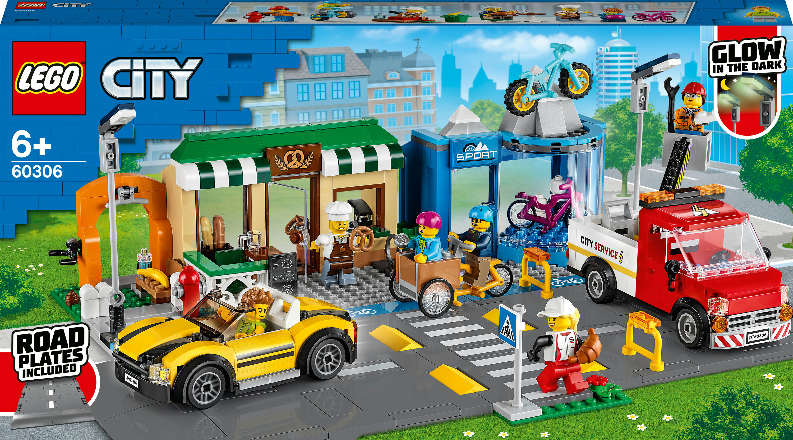 LEGO City seti. Binalar, araçlar ve çeşitli minifigürlerle bir şehir sahnesi.