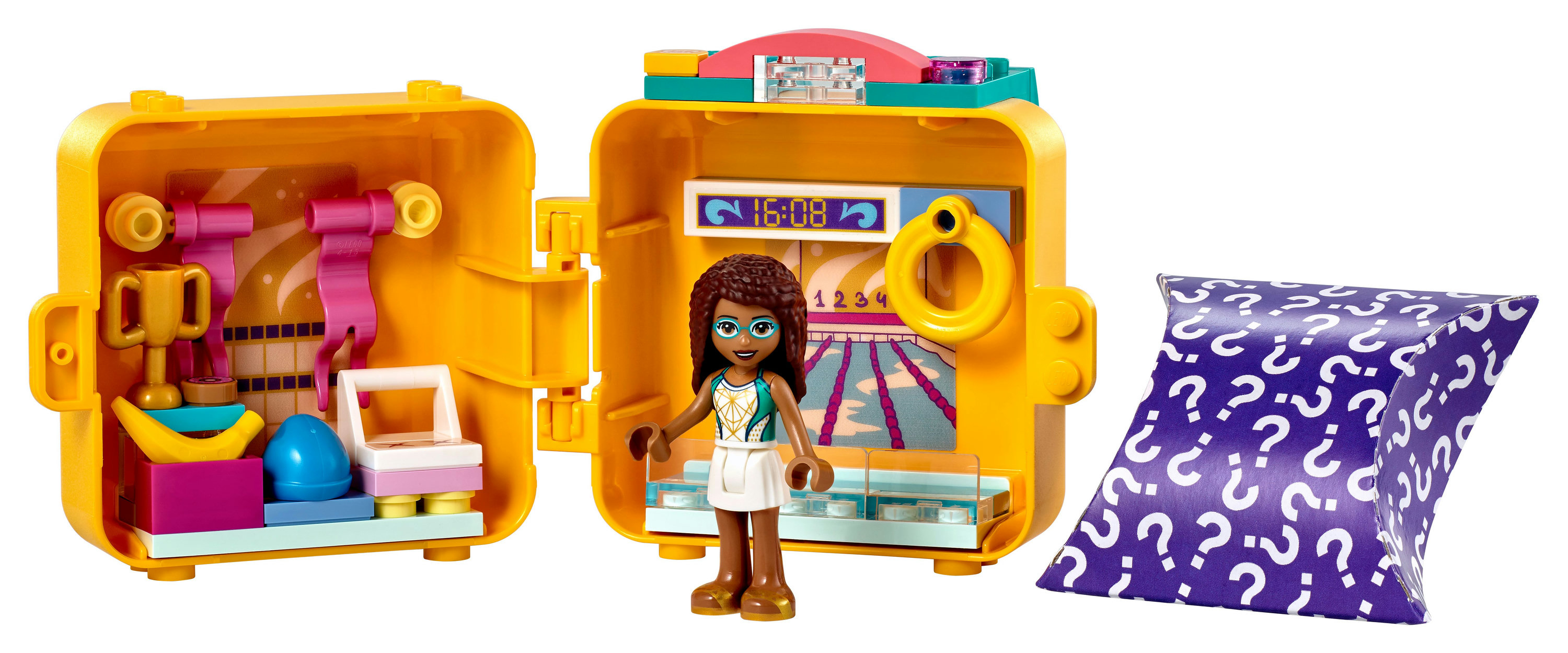 Zestaw Lego Friends, otwarte żółte pudełko z figurką, akcesoriami i fioletową torbą ze znakiem zapytania.