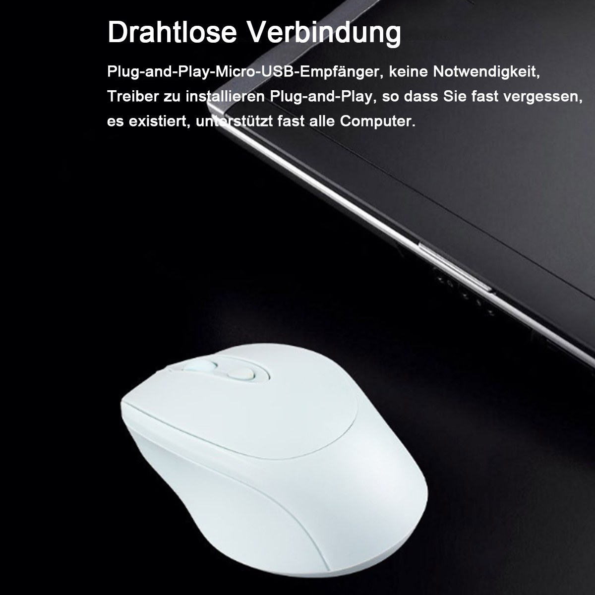 Eine weiße kabellose Maus auf einer schwarzen Oberfläche neben einem Laptop.