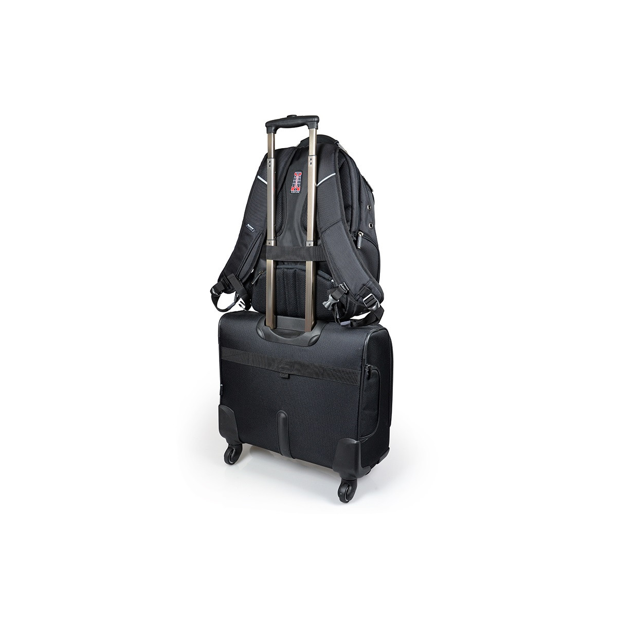 Black backpack on top of a black rolling suitcase, isolated on white background.