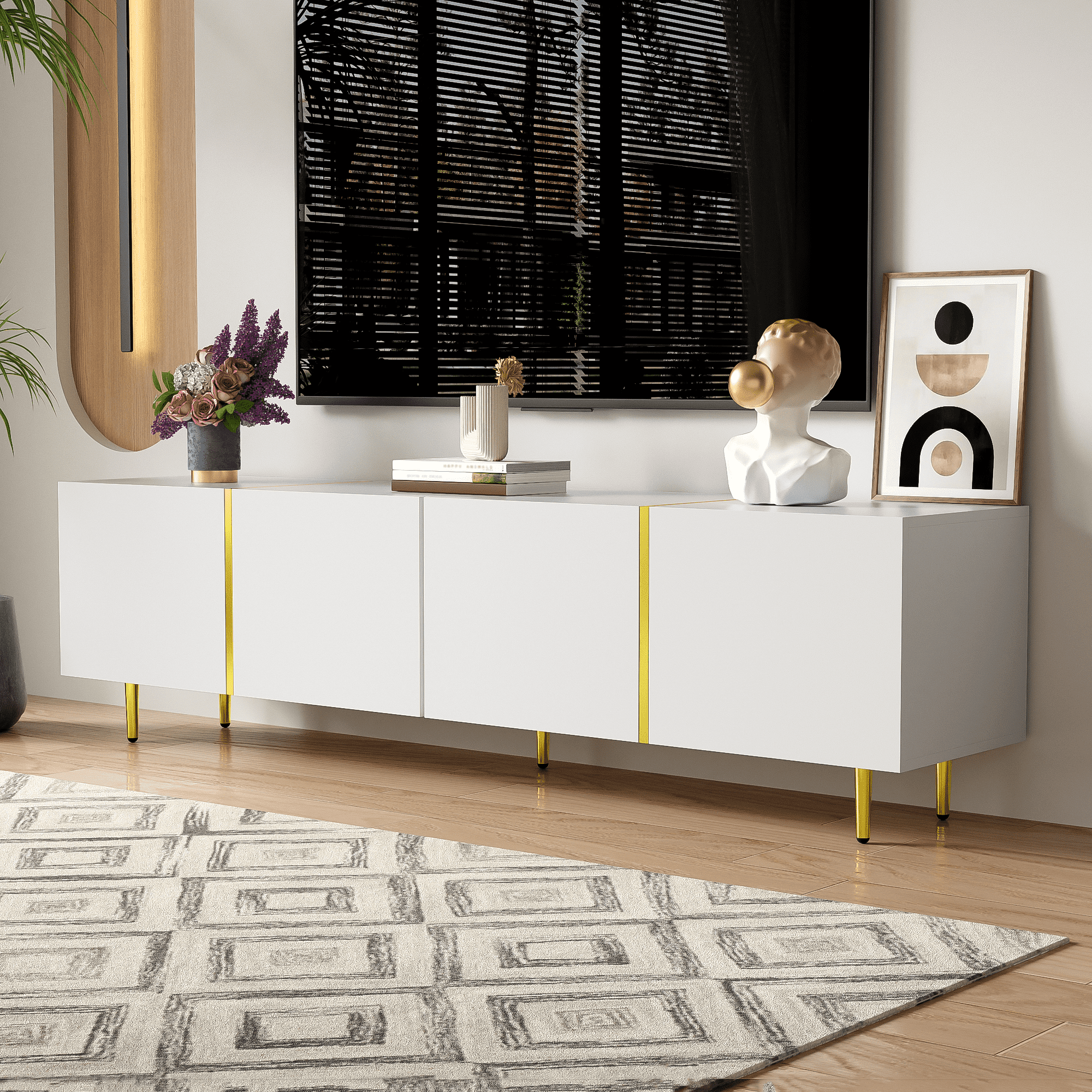 Weißer TV-Schrank mit goldenen Beinen. Oben steht ein Fernseher. Dekoartikel sind eine Büste und Kunst.