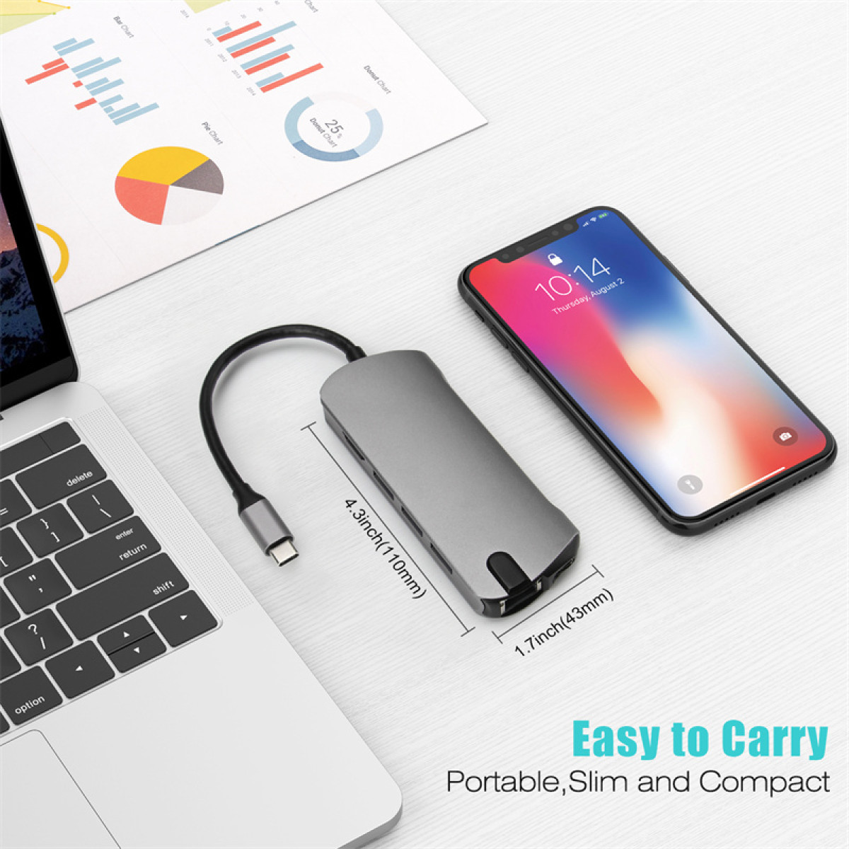 Una laptop, un concentrador USB y un teléfono con la hora 10:14 en la pantalla.