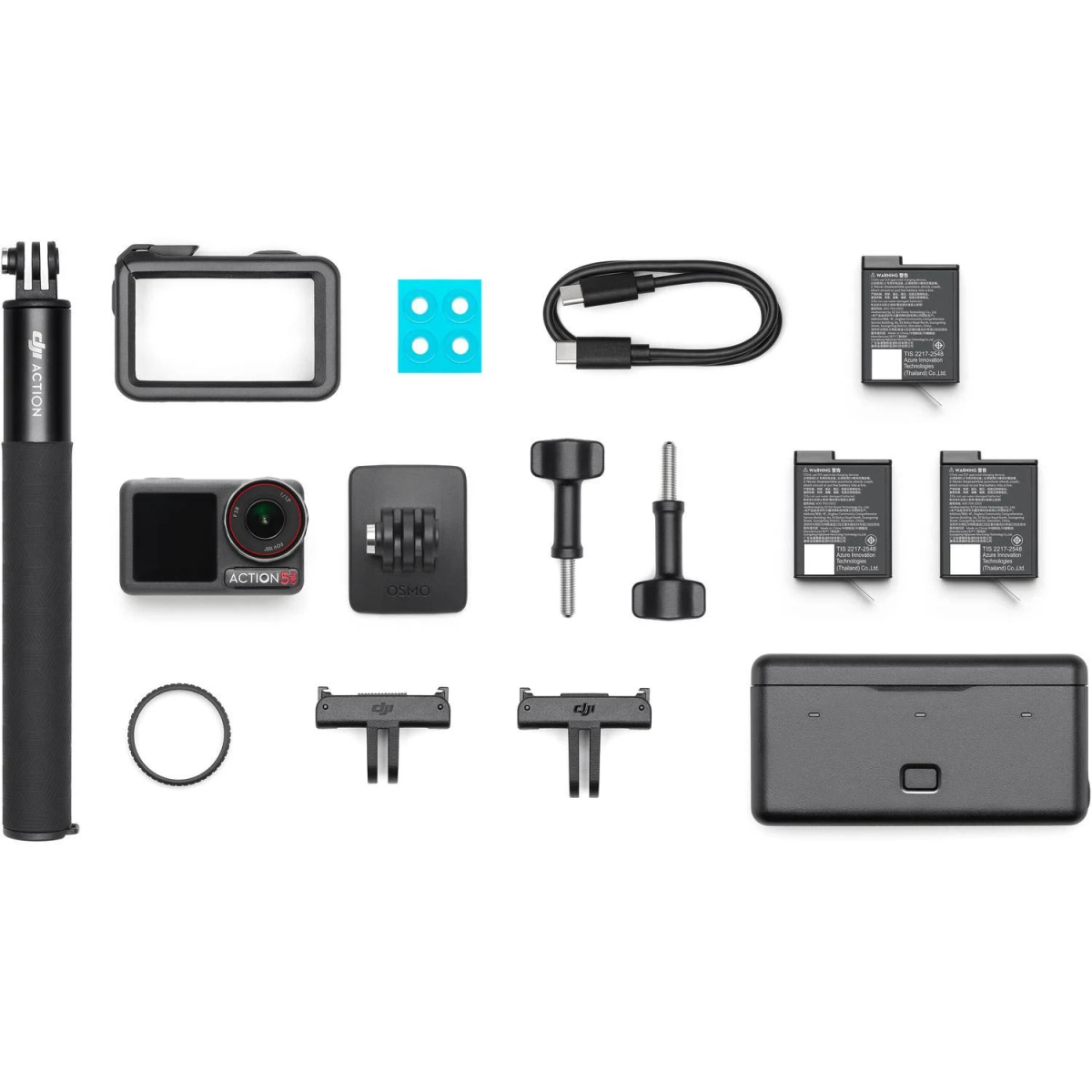 Kit fotocamera d'azione con vari accessori disposti su sfondo bianco. Include fotocamera, batterie e supporti.