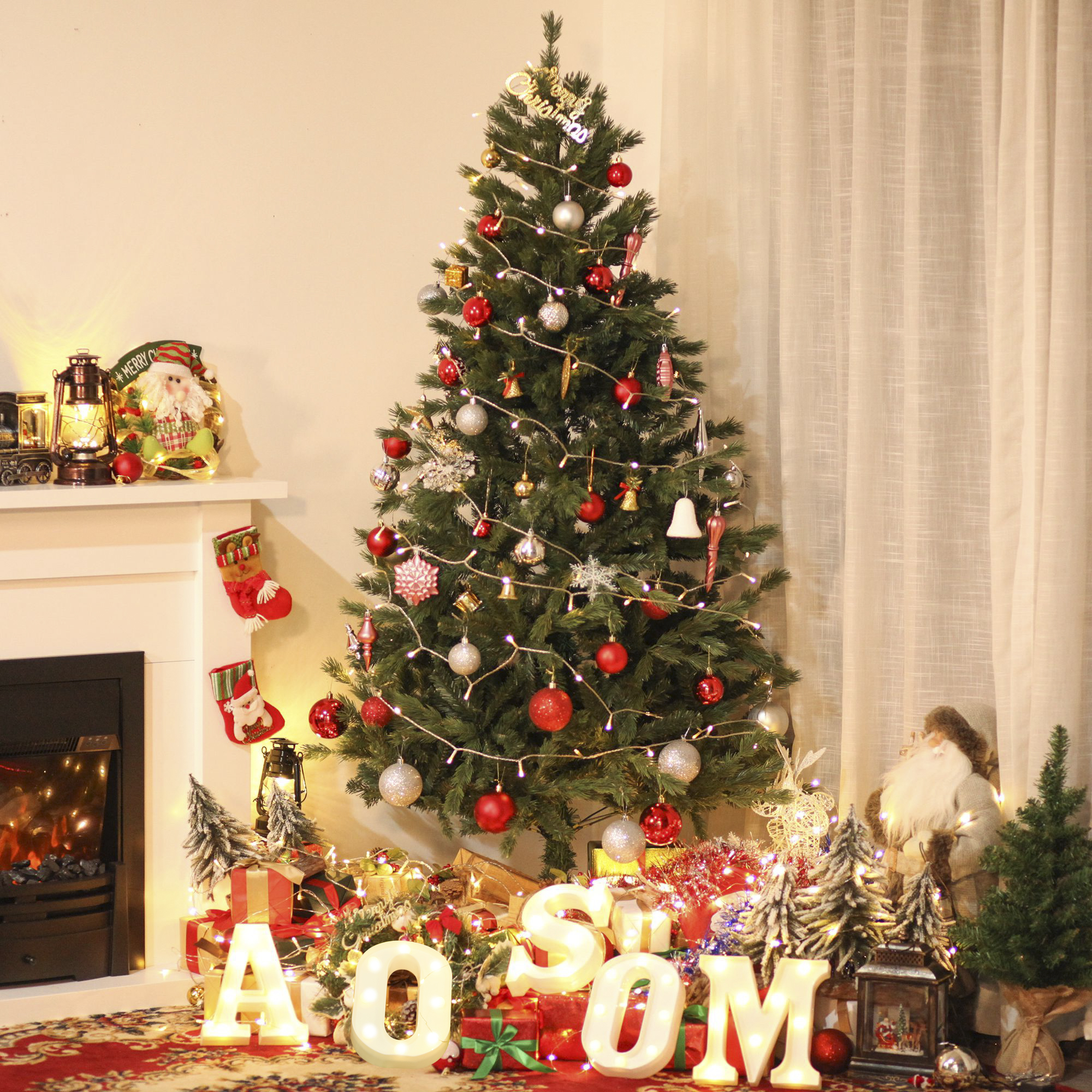 Árbol de Navidad decorado con luces, adornos y regalos, con chimenea y decoraciones.