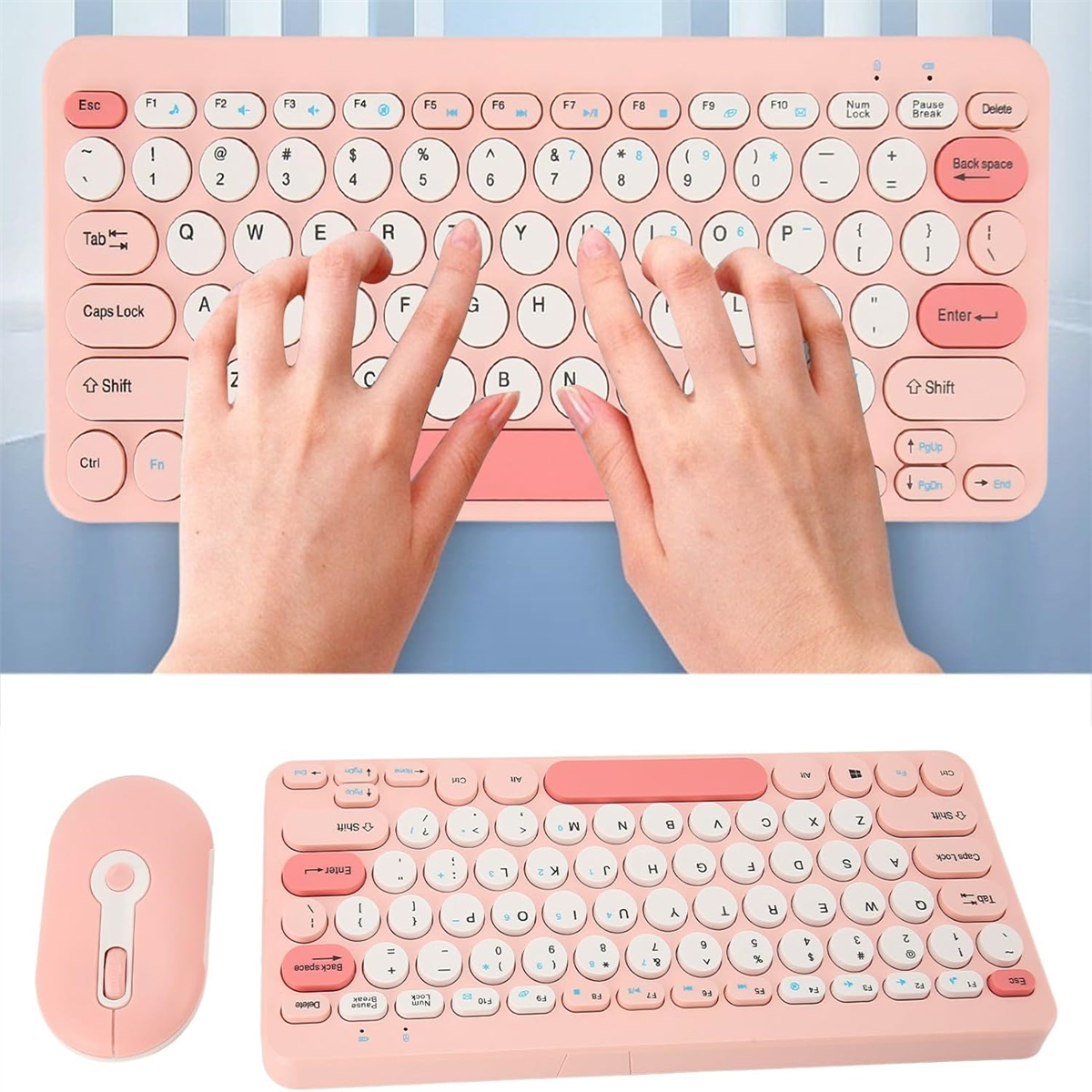 Ein pinkfarbenes Tastatur- und Maus-Set. Hände tippen auf der Tastatur. Weißer Hintergrund.