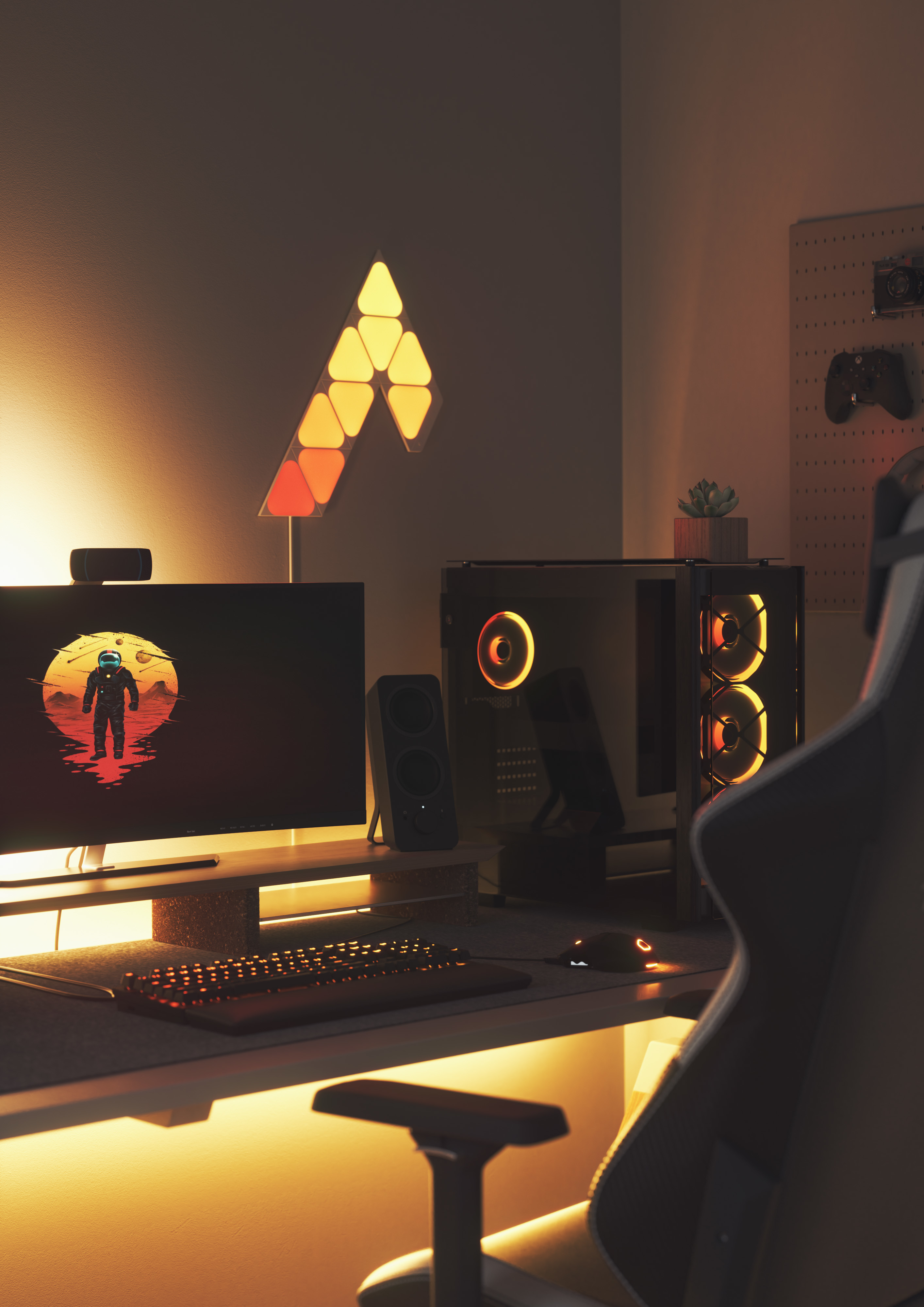 Un setup di gioco con un monitor che mostra un astronauta, illuminazione RGB e un PC.