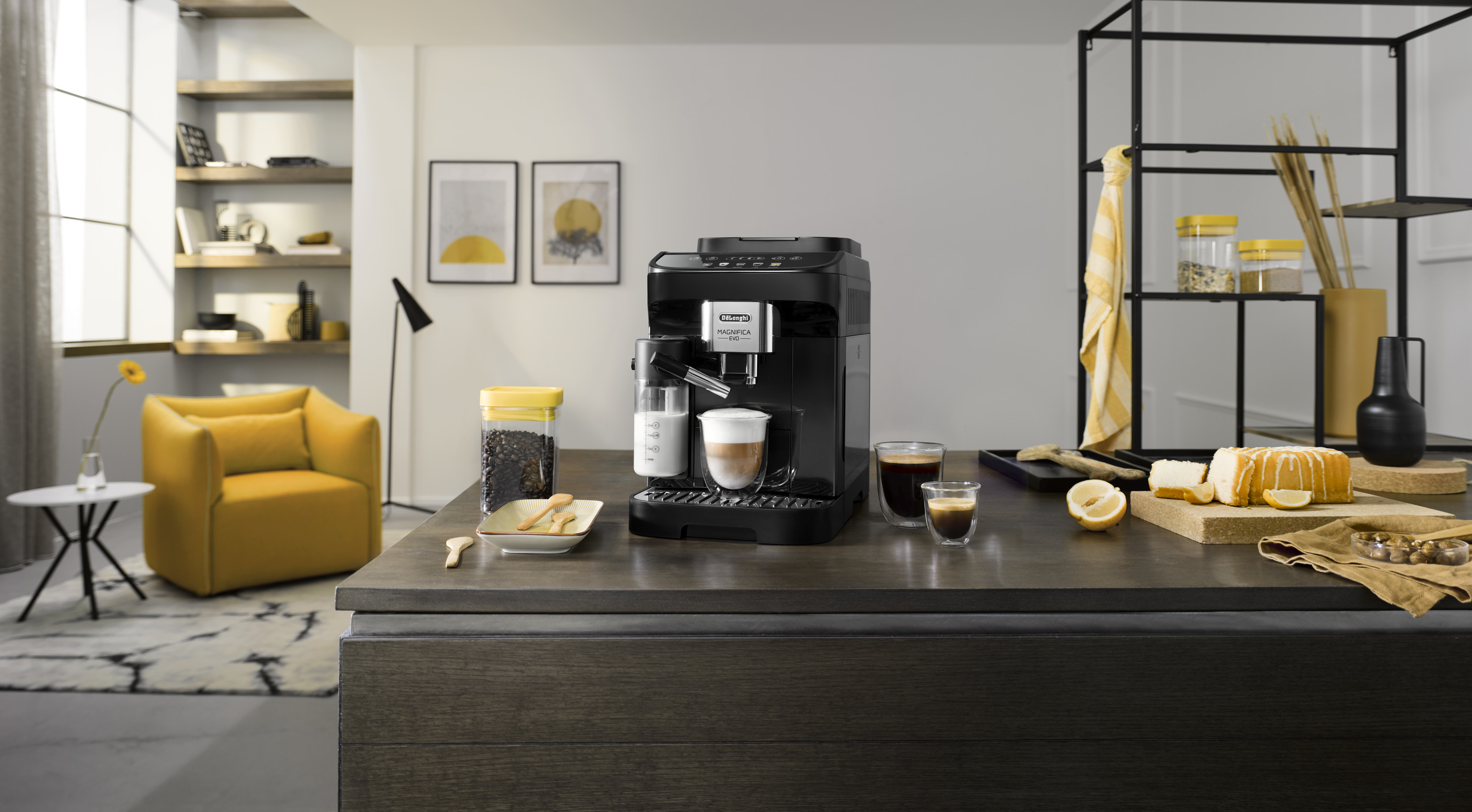 Black coffee machine on countertop, various food items and decor.