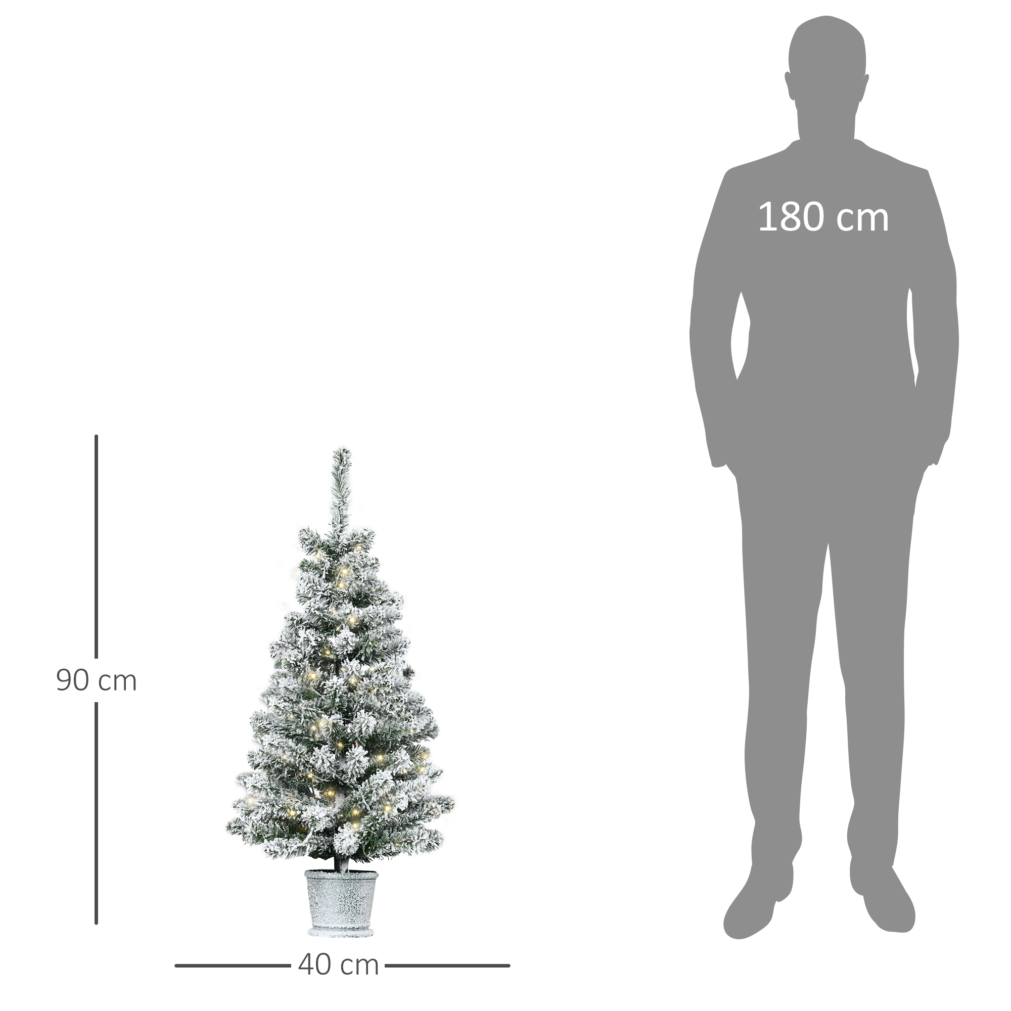 Un pequeño árbol de Navidad cubierto de nieve junto a una silueta de un hombre de 180 cm.