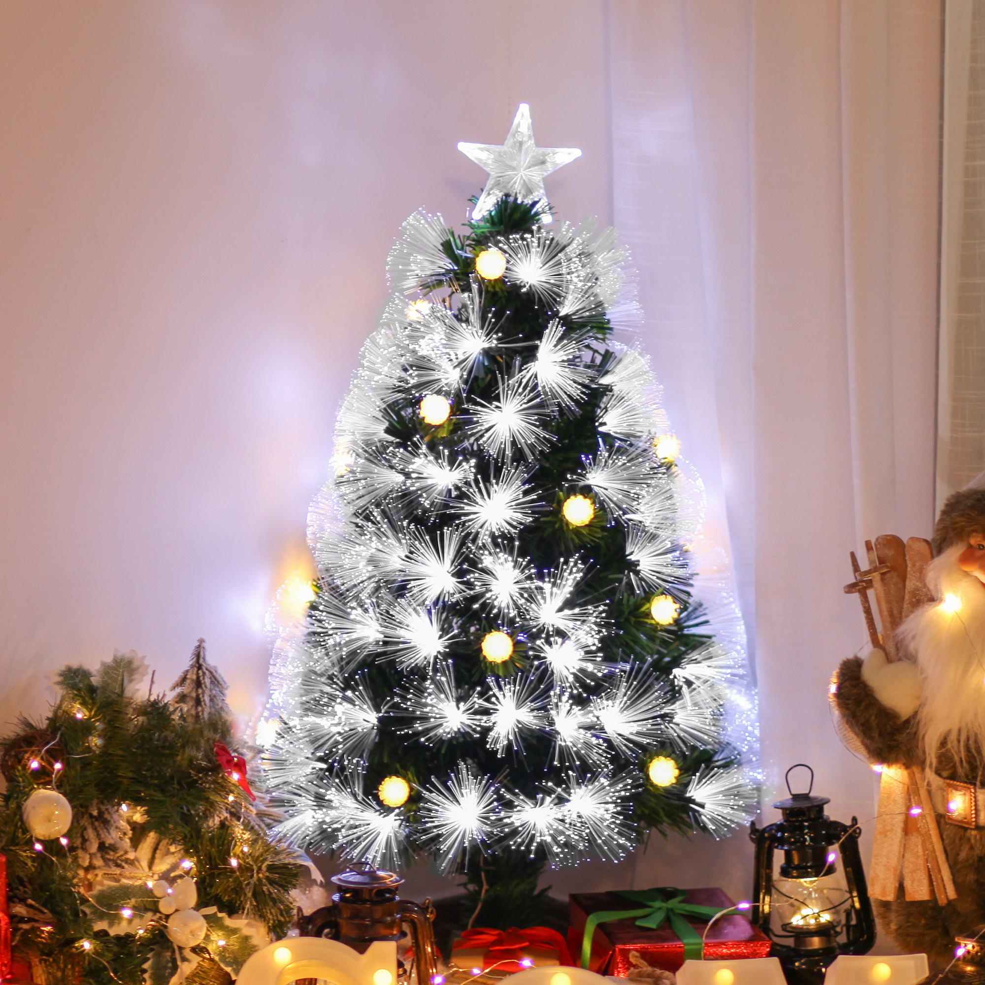 Árbol de Navidad decorado con estrella, luces y regalos en un ambiente festivo.