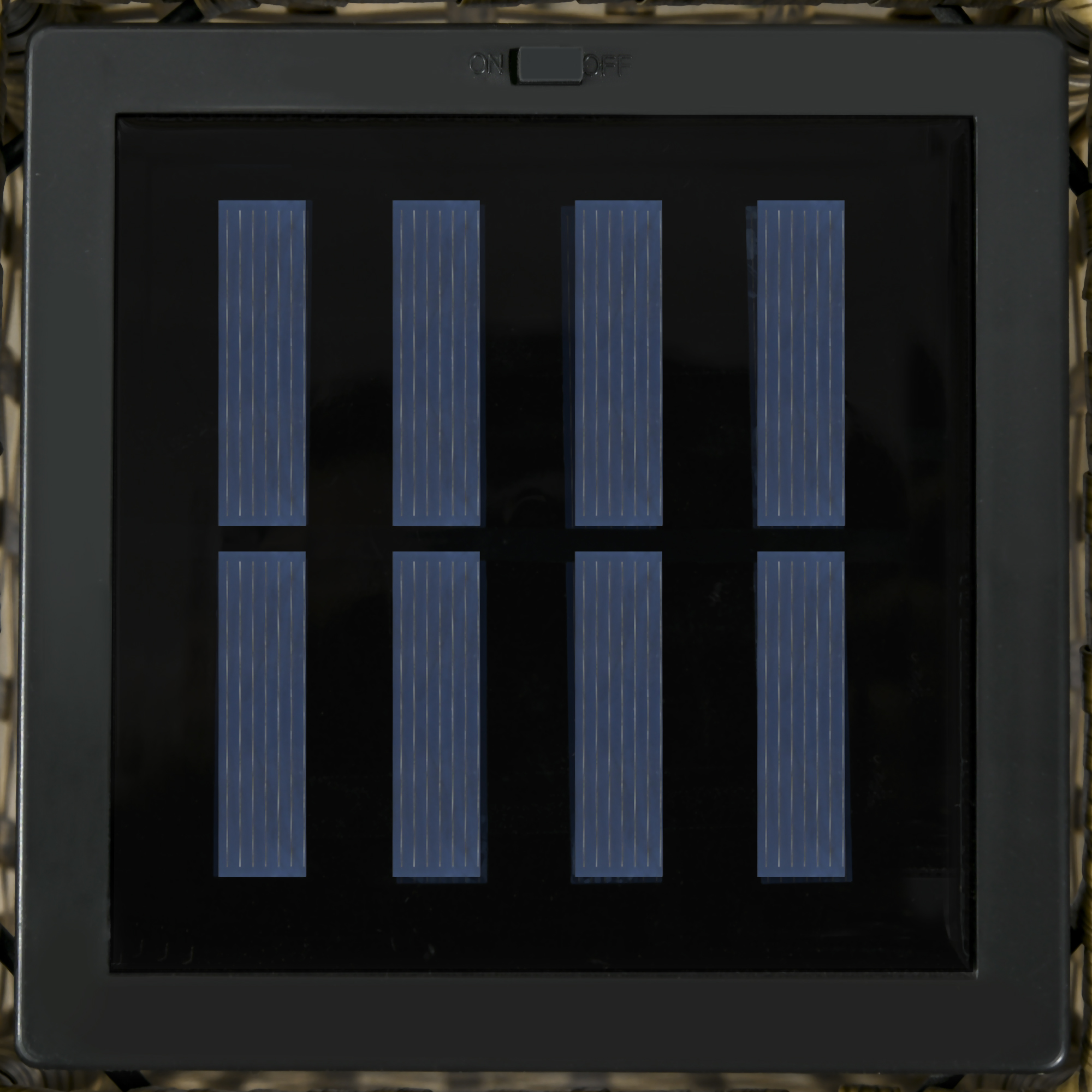 Un panel solar negro con ocho celdas rectangulares azules y un interruptor de encendido/apagado arriba.
