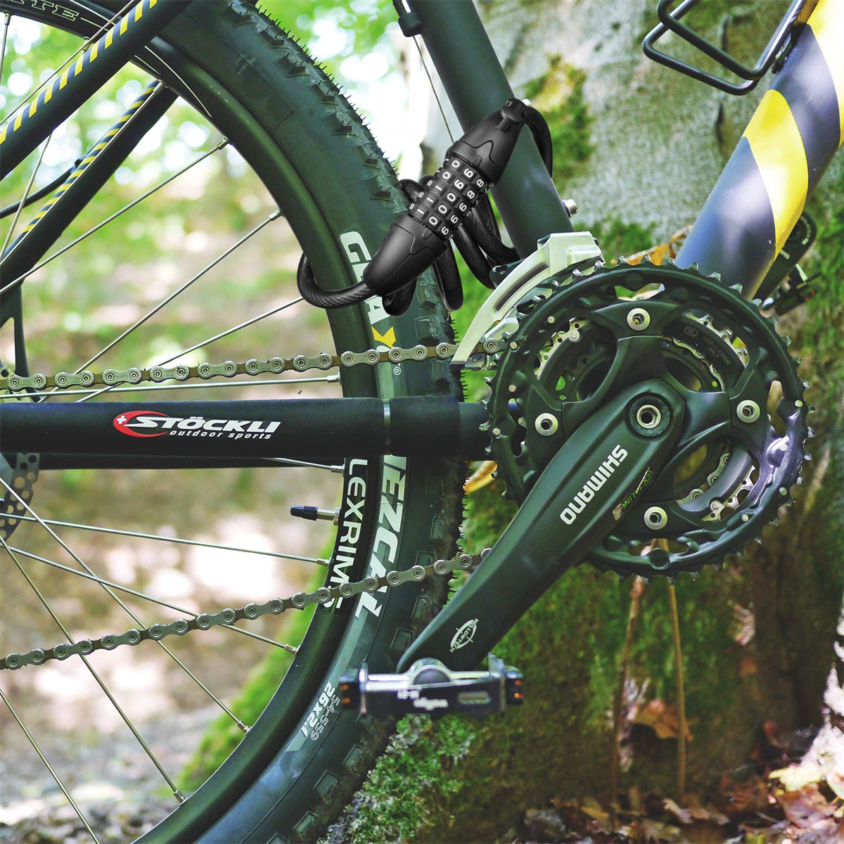 Ein Fahrrad mit Zahlenschloss, das es an einer Stange sichert. Shimano-Gänge sind sichtbar.