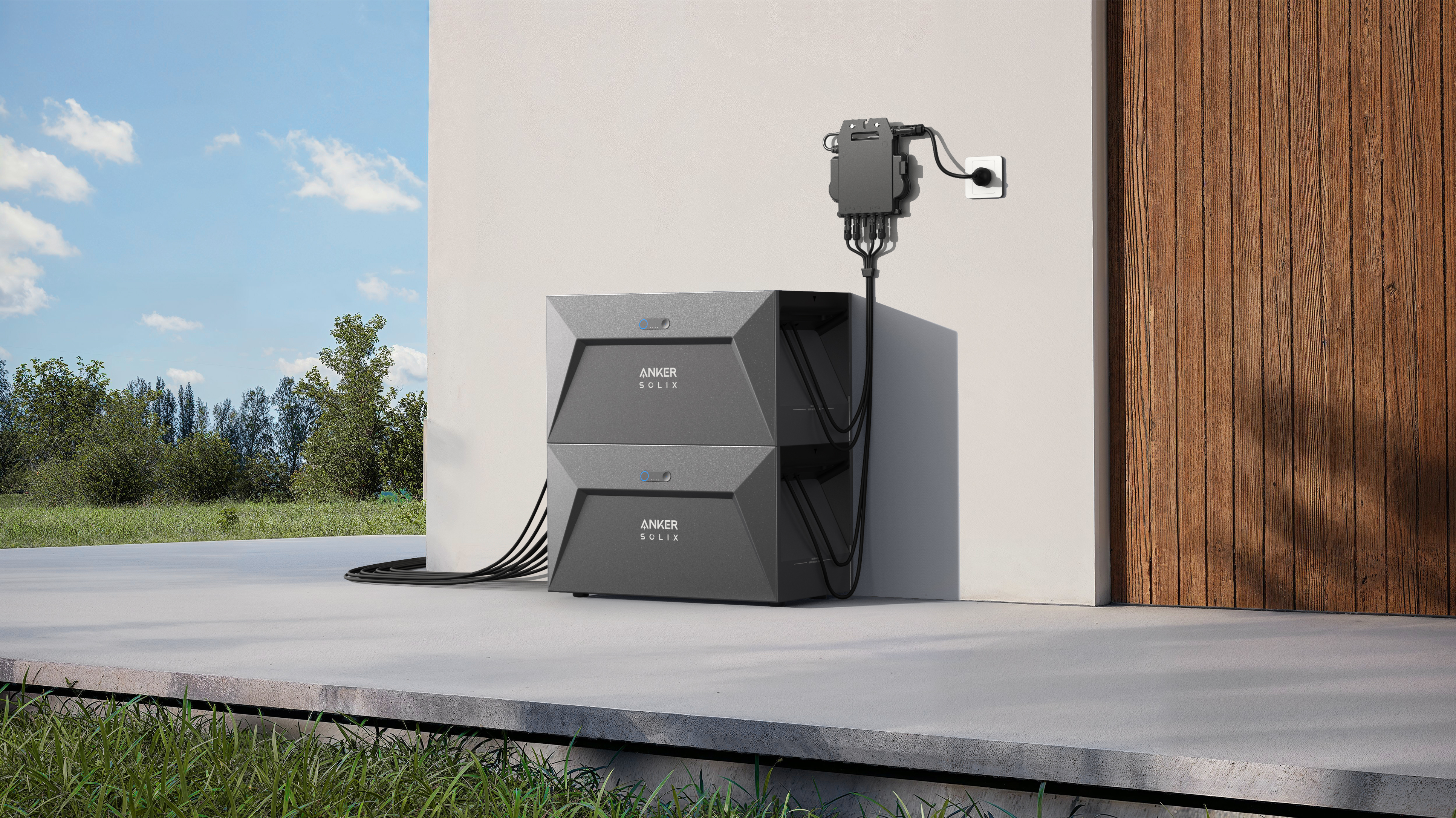 System paneli słonecznych zainstalowany na ścianie, z akumulatorami i kablami zasilającymi, w słoneczny dzień.