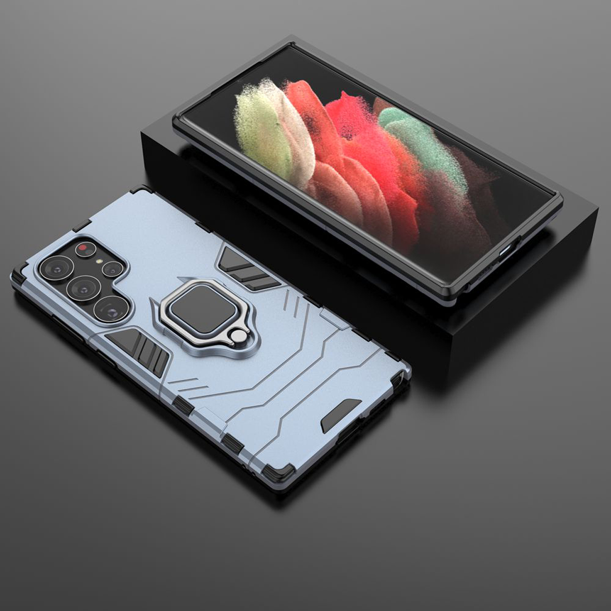 Een lichtblauwe telefoonhoes met een ringhouder en een telefoon op een zwart oppervlak.