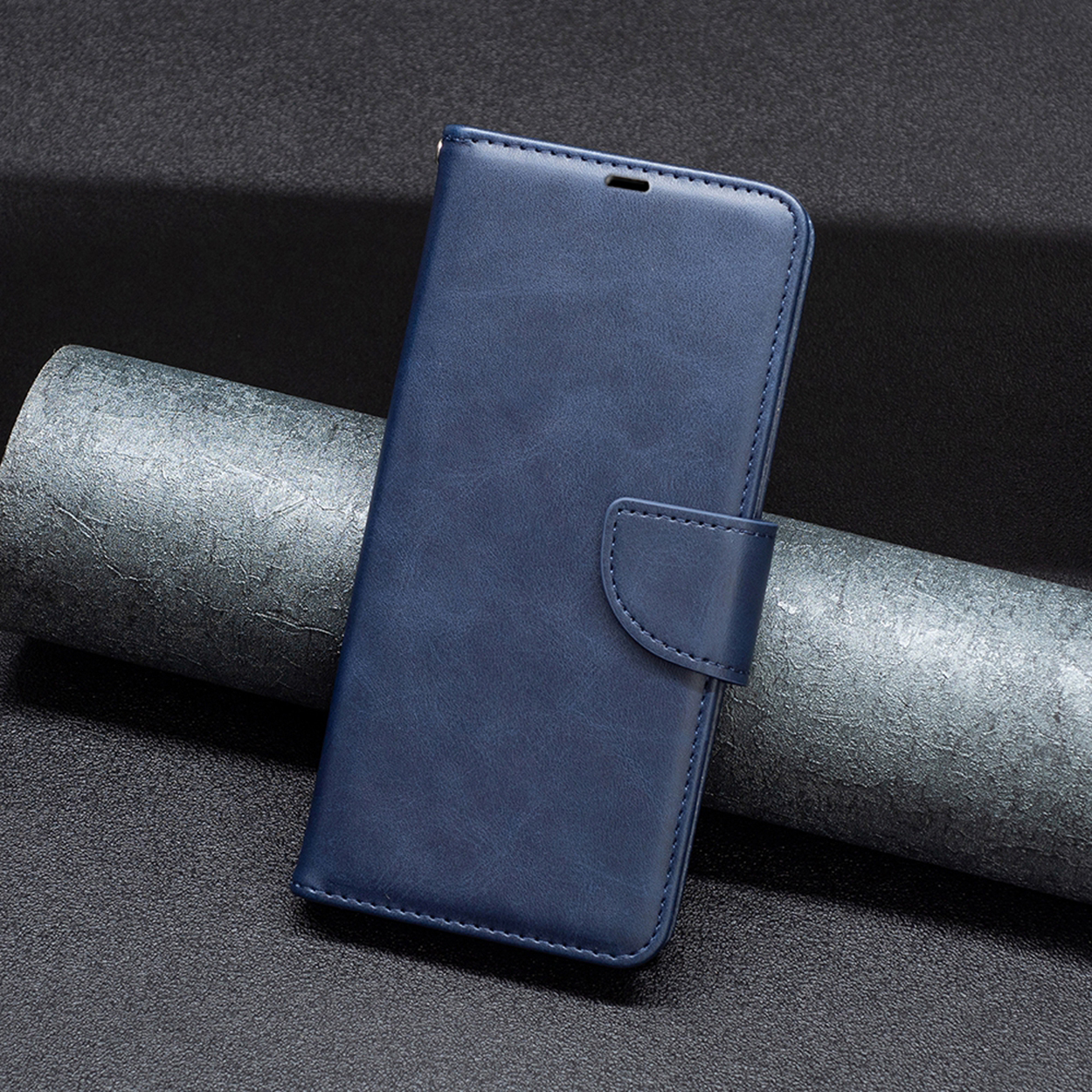 Blauwe leren telefoonhoes gesloten. Verticaal. Knopensluiting. Oppervlak met textuur en stiksels.