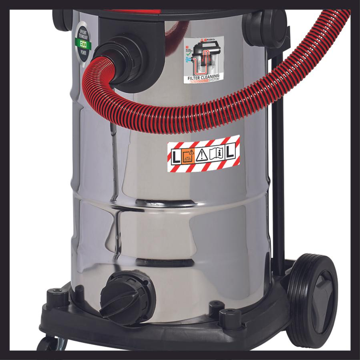 Odkurzacz ze stali nierdzewnej z czerwonym wężem, czarnymi kołami i etykietami ostrzegawczymi.