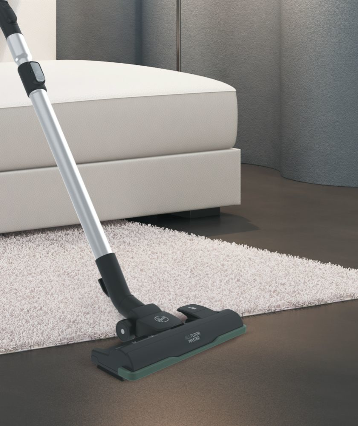 A vacuum cleaner head on a white rug. A sofa is in the blurred background.