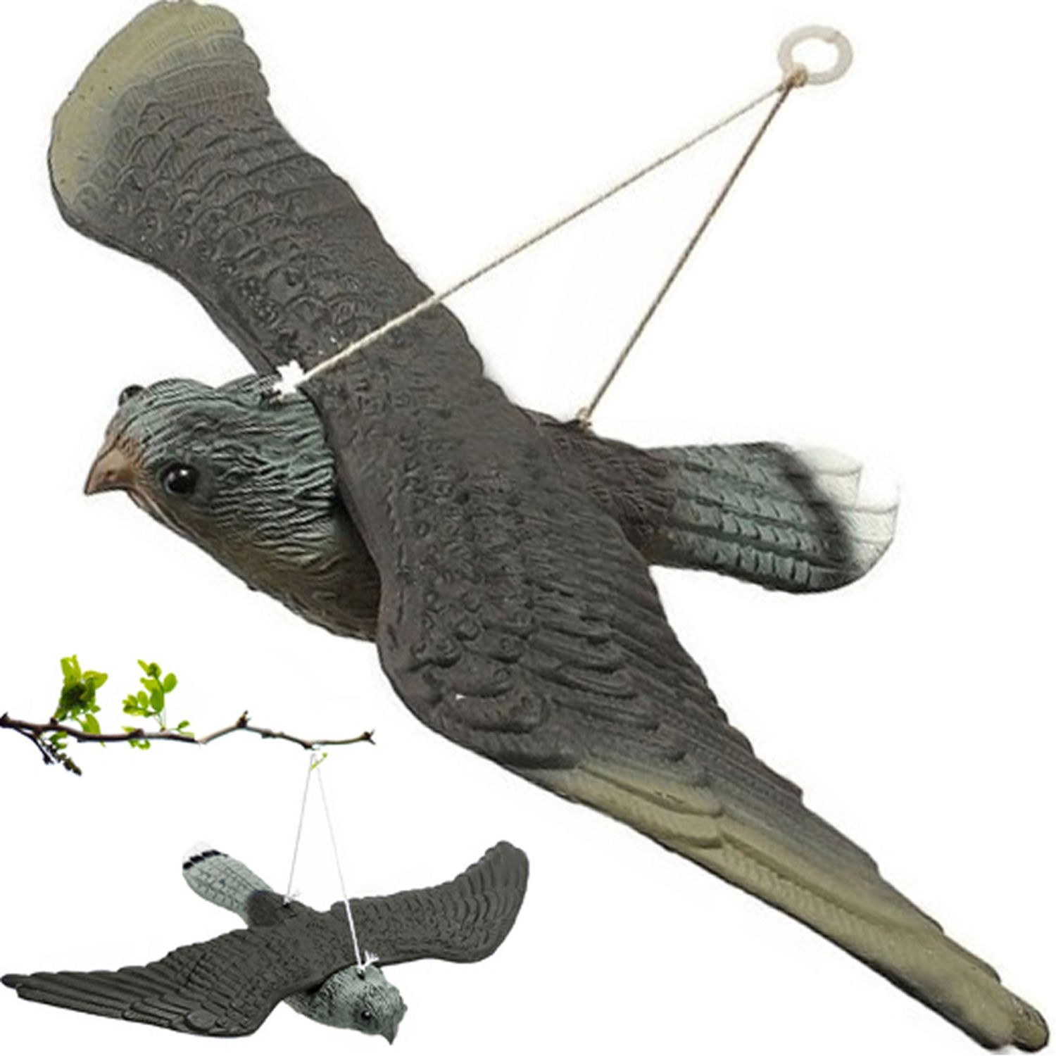 Finto uccello in volo con spago. Un altro uccello finto sotto. Ramo verde in basso.