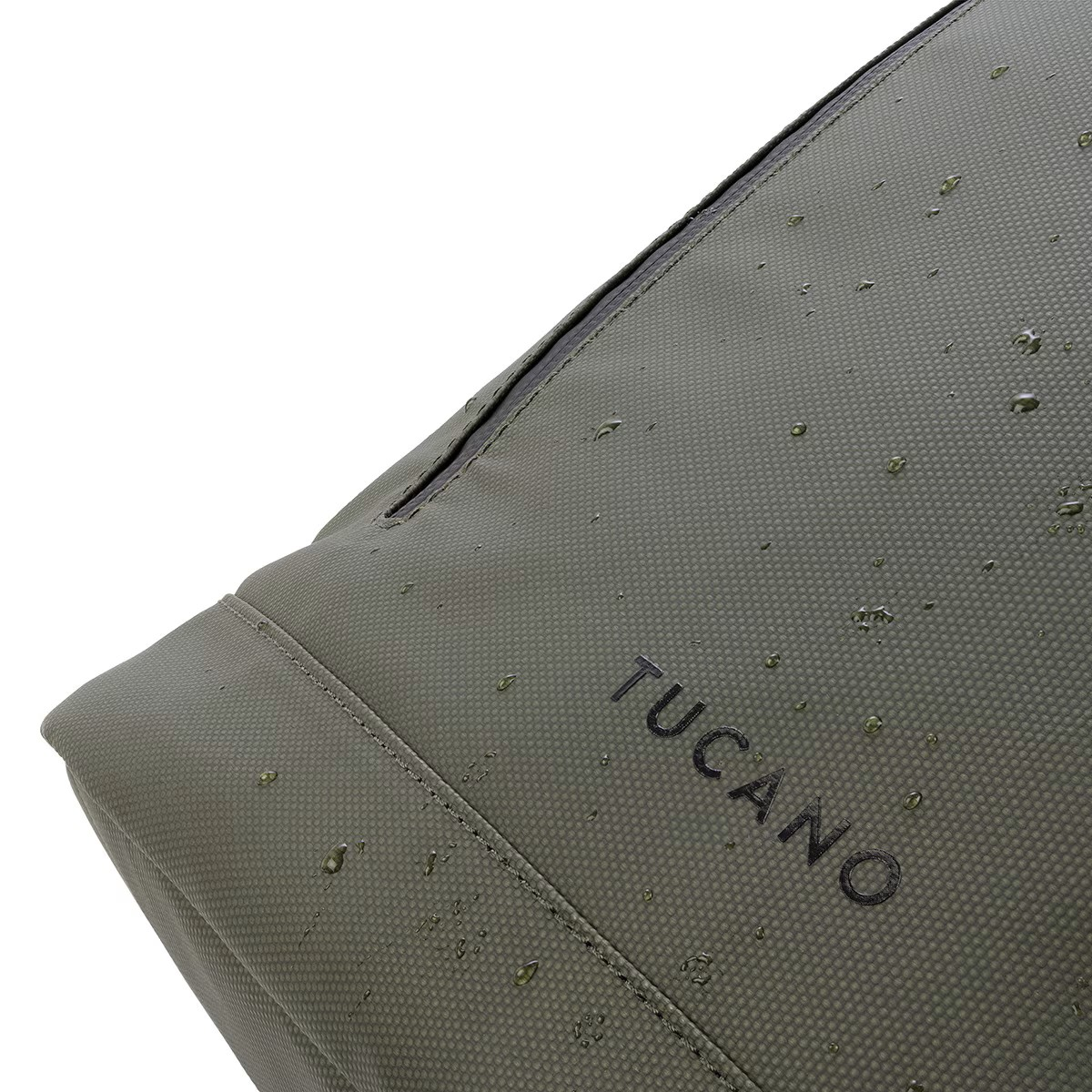 Eine grüne Tucano-Tasche mit Wassertropfen. Das Wort 'TUCANO' ist sichtbar.