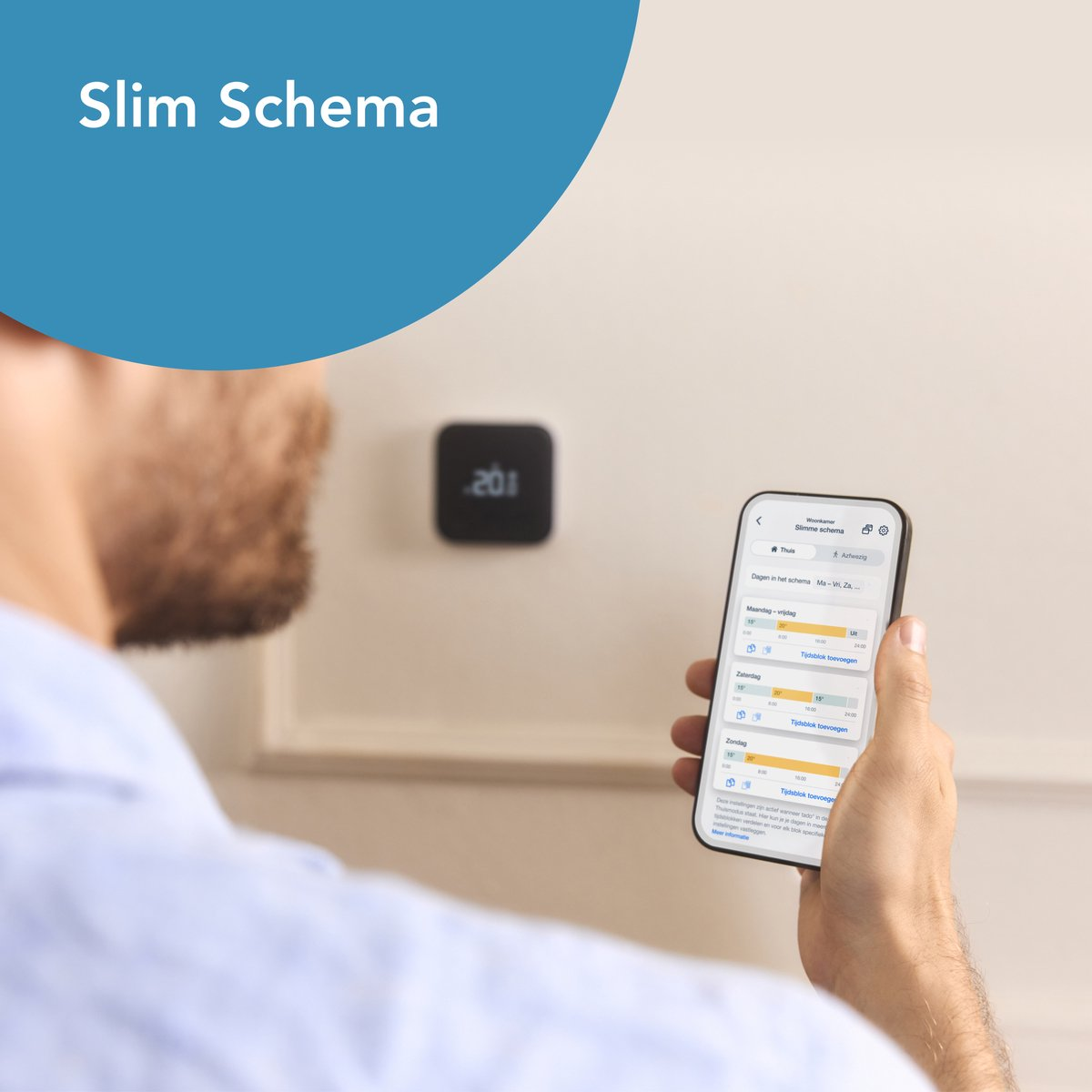 A man using a phone with home control app. A thermostat is on the wall.