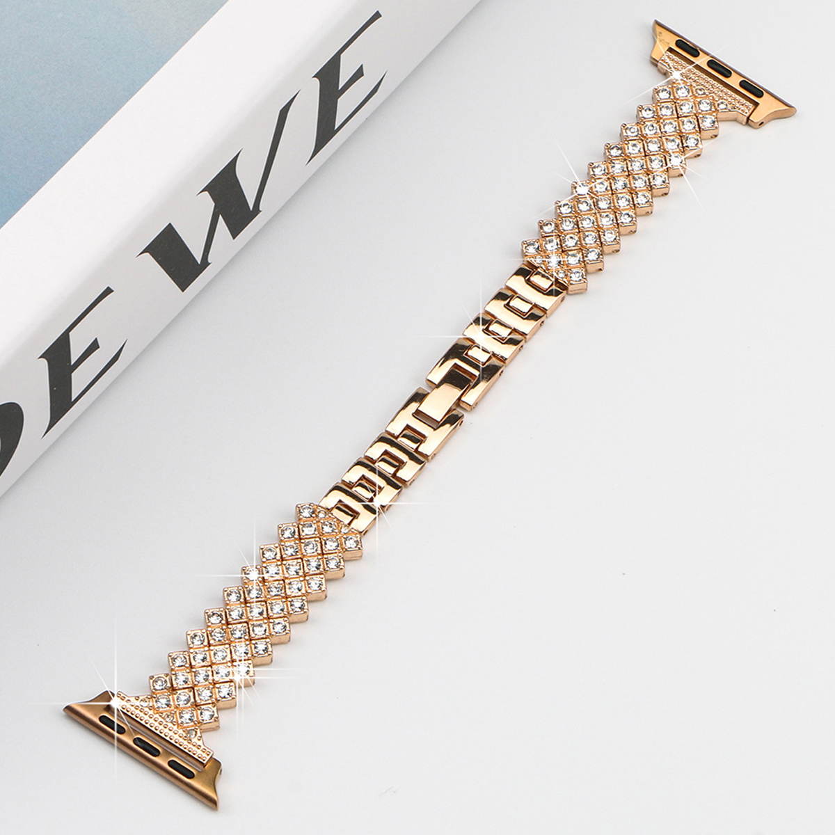 Ein goldenes Apple Watch-Armband mit Strasssteinen.