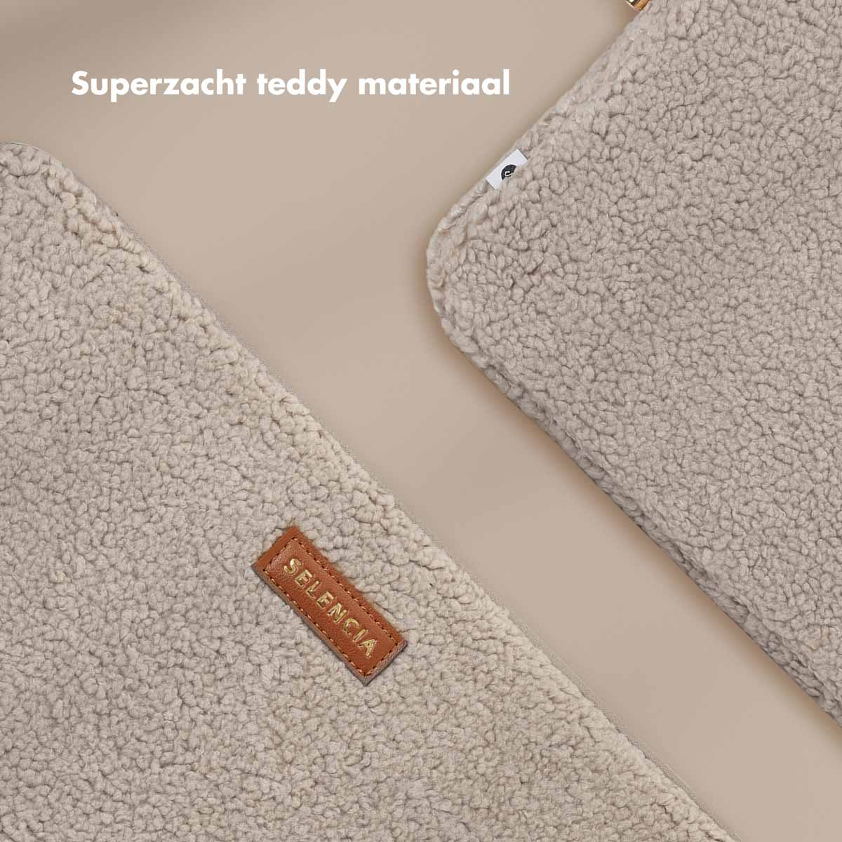 Two pieces of beige teddy material. One piece has a brown label.