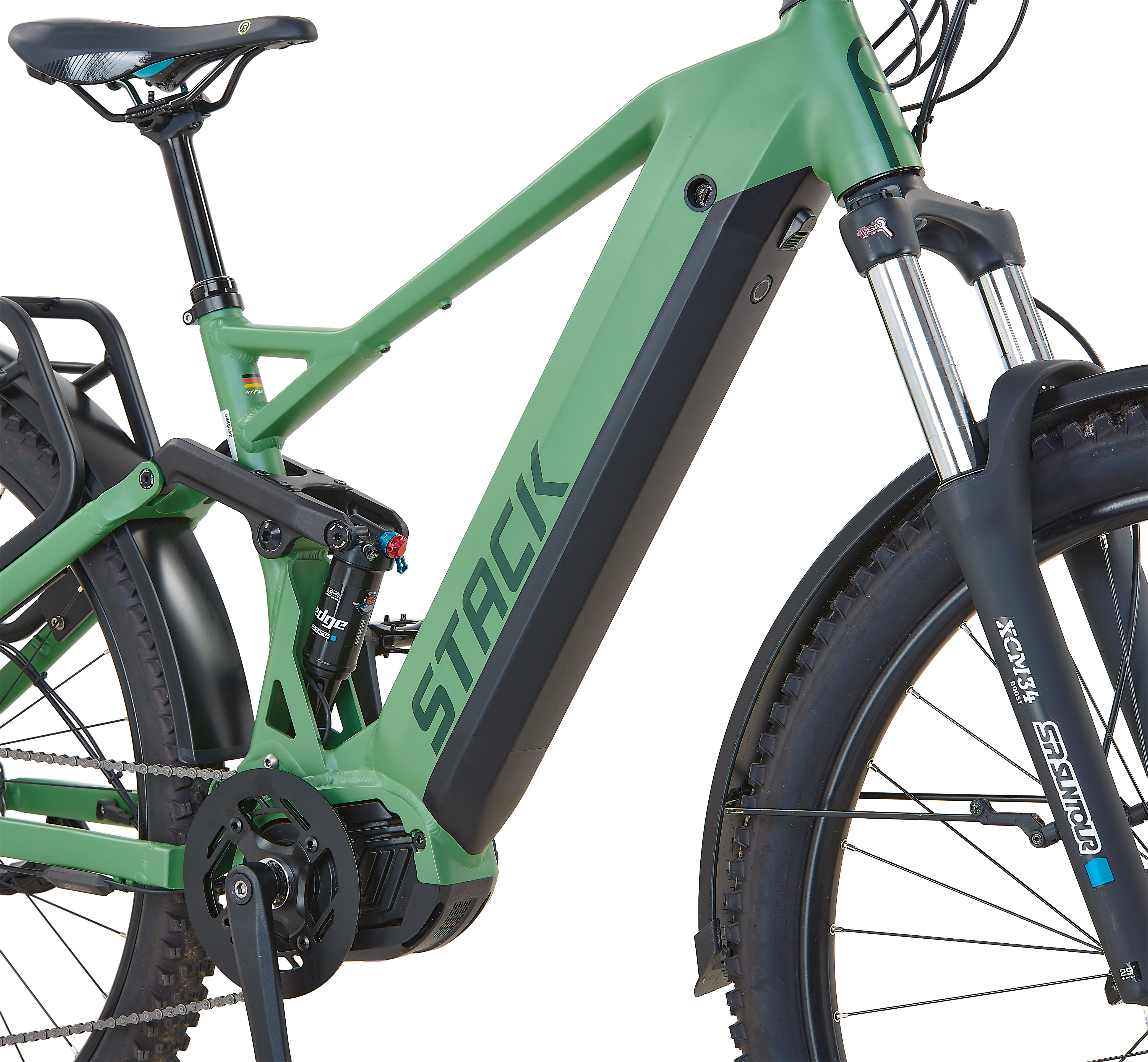 Grünes E-Bike mit schwarzem Gepäckträger, Federung und breiten Reifen.