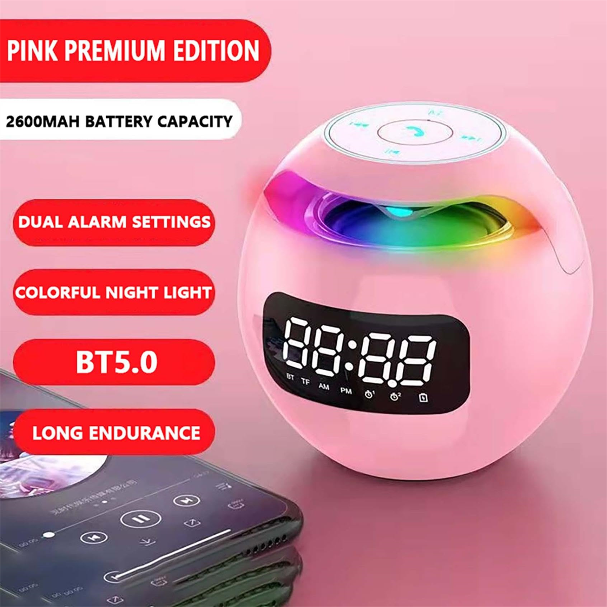 Pinker Wecker mit Digitalanzeige, farbigem Lichtring und Telefon in der Nähe.
