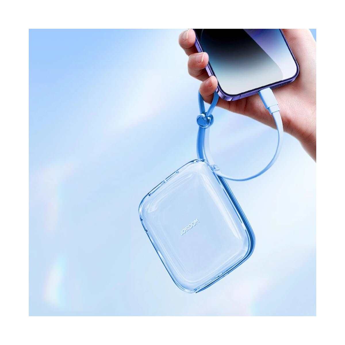 Ein blaues Telefon, das mit einem blauen Kabel und einer weißen Powerbank geladen wird. Der Hintergrund ist blau.